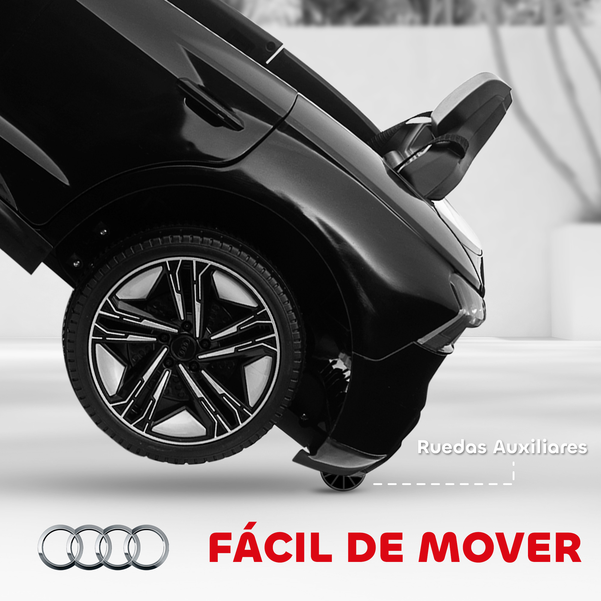 Coche de juguete negro con una rueda enfocada. El texto dice 'FÁCIL DE MOVER' y 'Ruedas Auxiliares'.