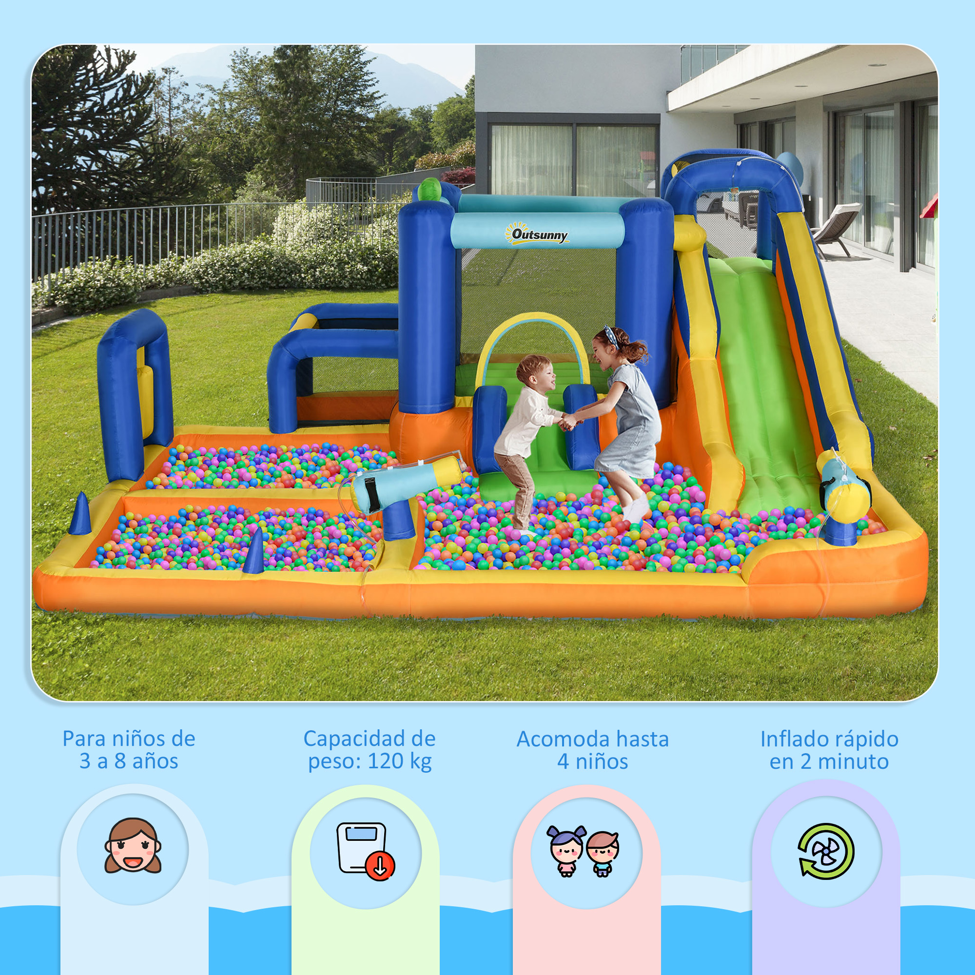 Estructura inflable con tobogán y piscina de bolas. Dos niños saltan dentro. Césped verde y una casa al fondo.