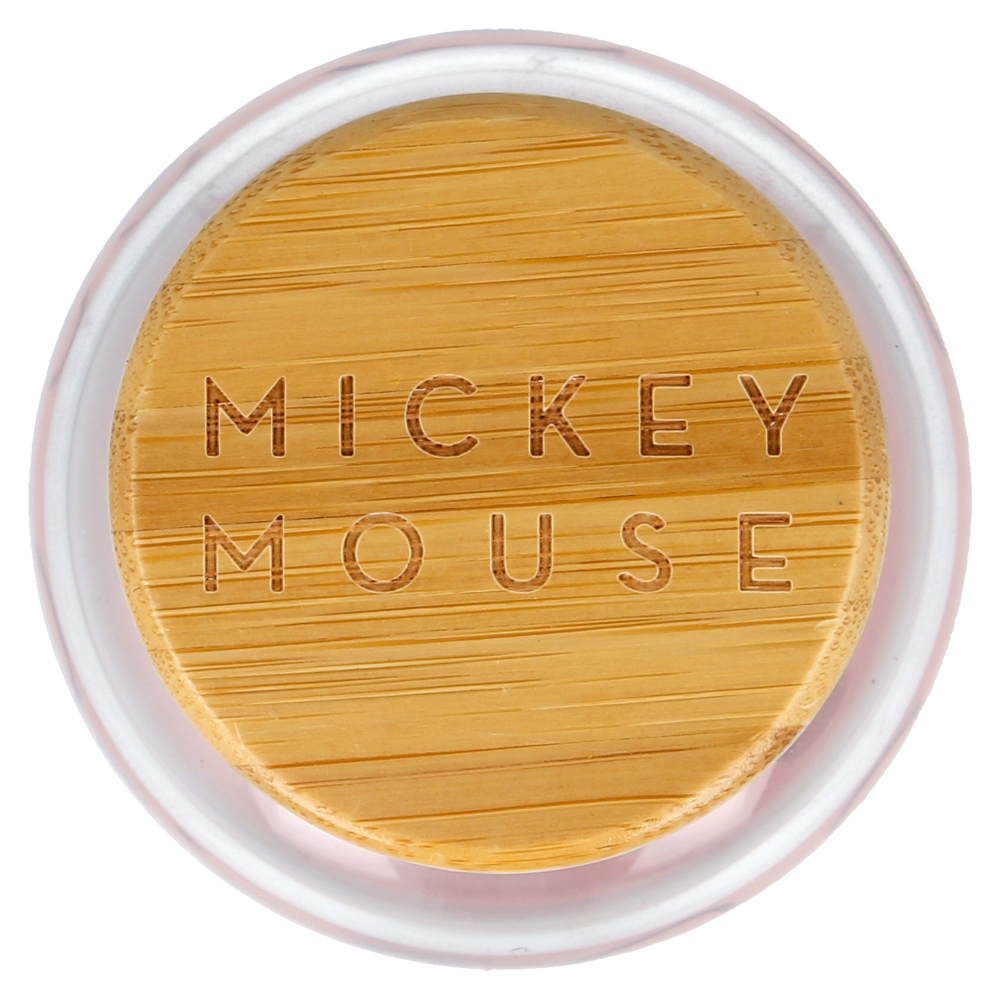 Un frasco con tapa de madera. La tapa tiene grabado 'MICKEY MOUSE'. El frasco tiene un borde claro y rosado.