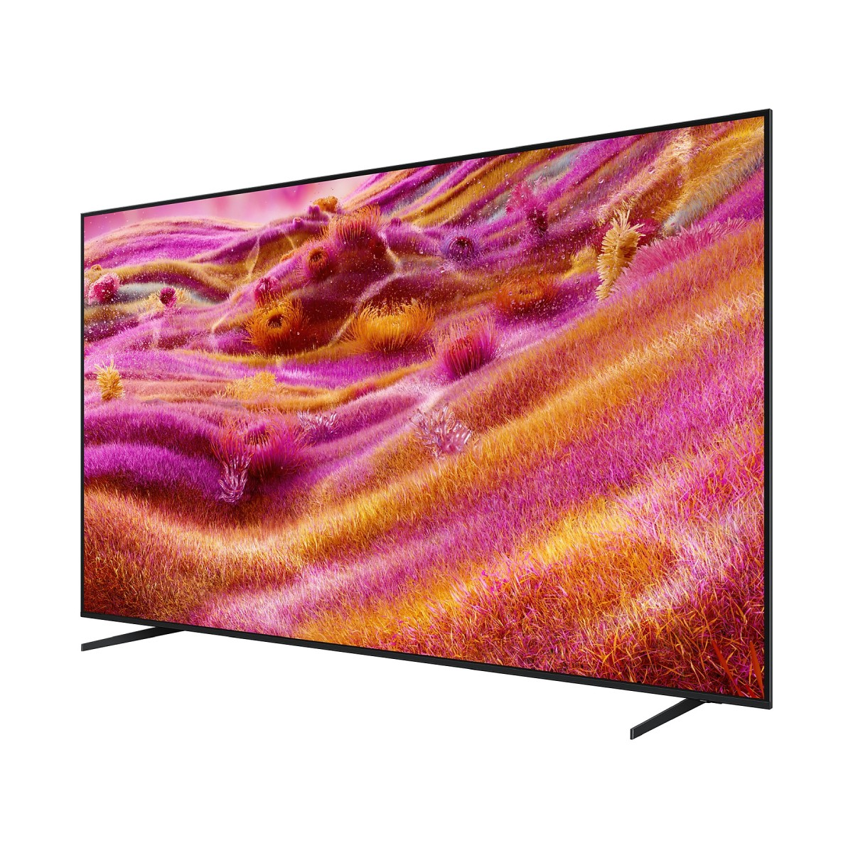 Un grande televisore mostra un paesaggio colorato di colline erbose rosa, arancioni e gialle. Il televisore è nero e ha due gambe.