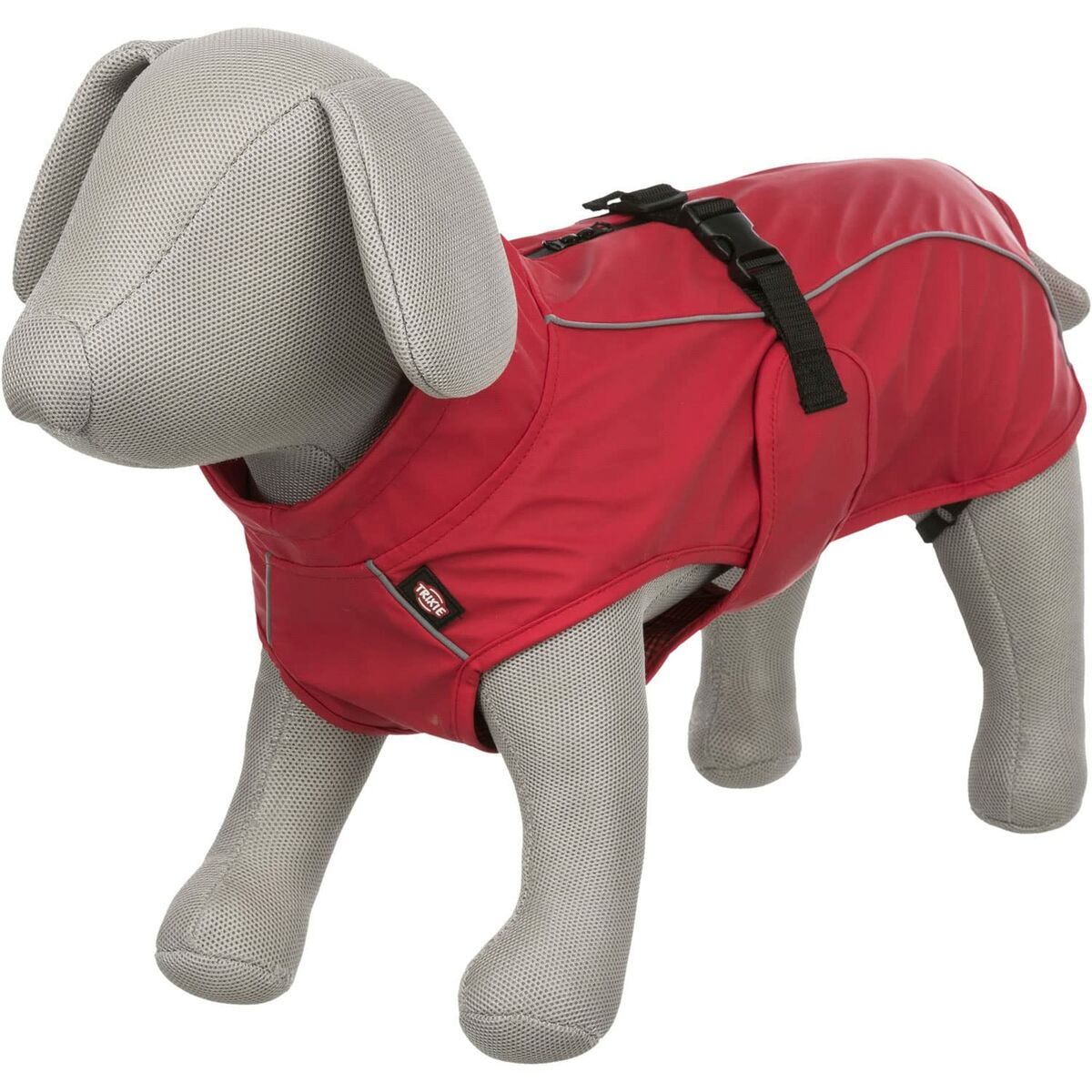 Ein Hunde-Mannequin in einem roten Hundemantel. Der Mantel hat schwarze Riemen und eine reflektierende Paspel. Die Mannequin ist grau.