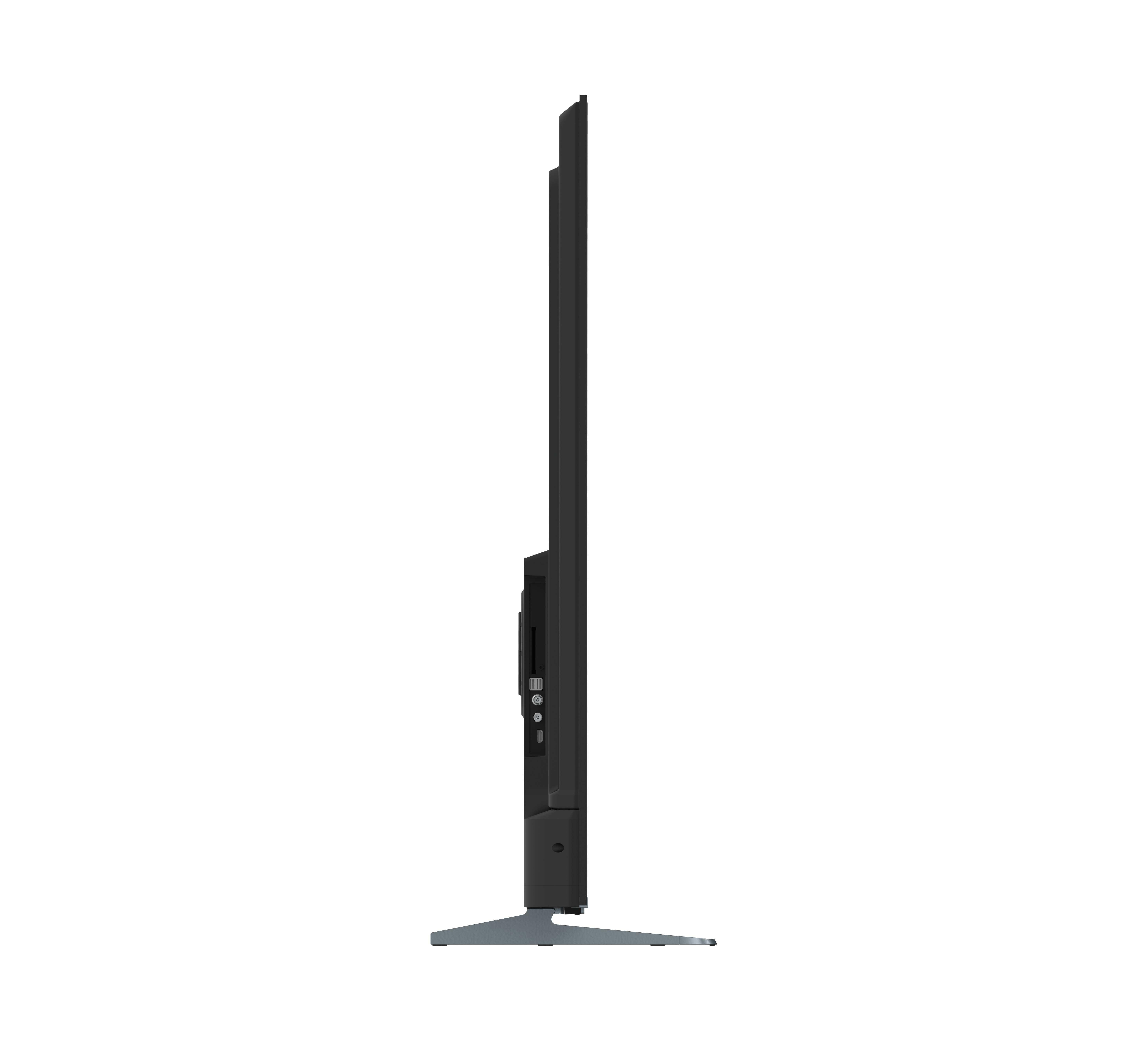 Vista laterale di una TV nera. Lo schermo è sottile. È in piedi su un supporto argentato.