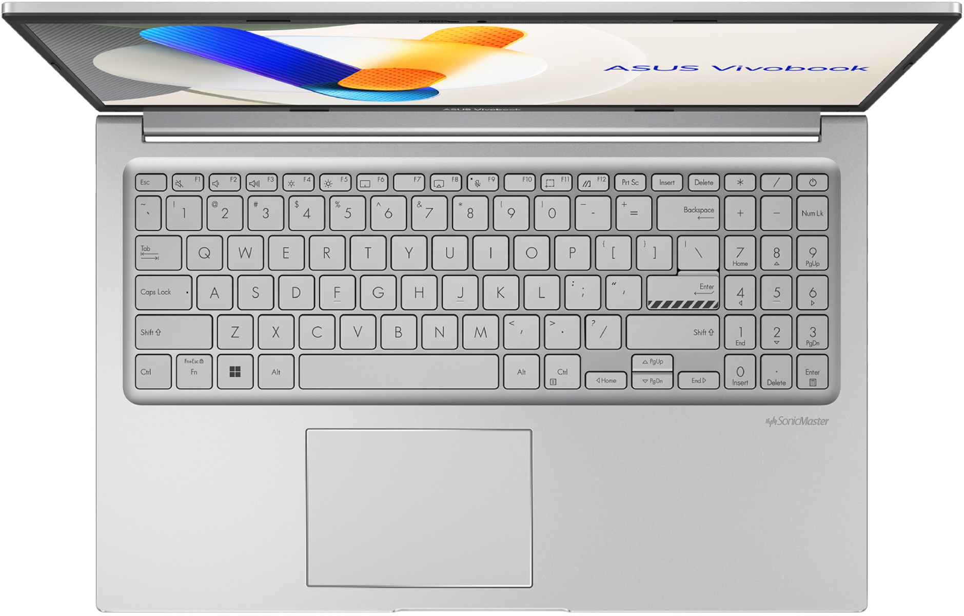 Una laptop ASUS Vivobook plateada está abierta. El teclado tiene teclas blancas con letras negras. La pantalla muestra una imagen colorida.