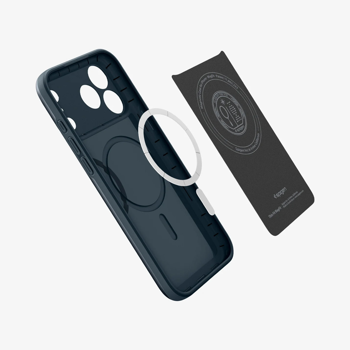 Custodia per telefono blu scuro con anello circolare bianco e scheda rettangolare nera. La custodia è aperta, l'anello separato.