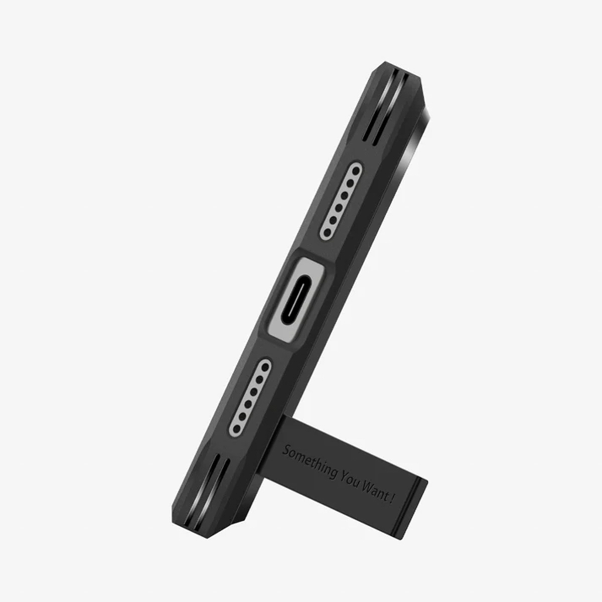 Une coque de téléphone noire avec un support indiquant 'Something You Want!'. La coque a un port de charge et des trous pour haut-parleurs.