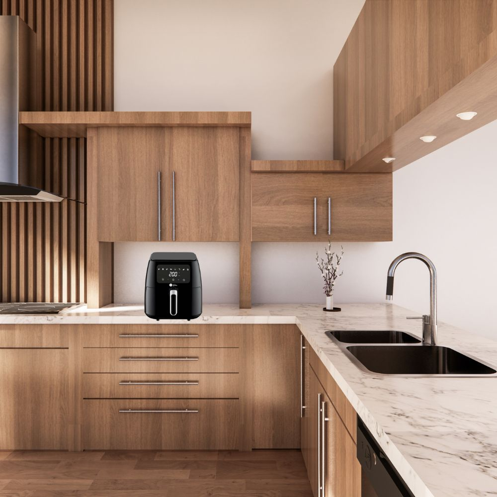 Una cocina moderna con armarios de madera. Una freidora de aire negra está sobre la encimera. Un fregadero y grifo en el fondo.