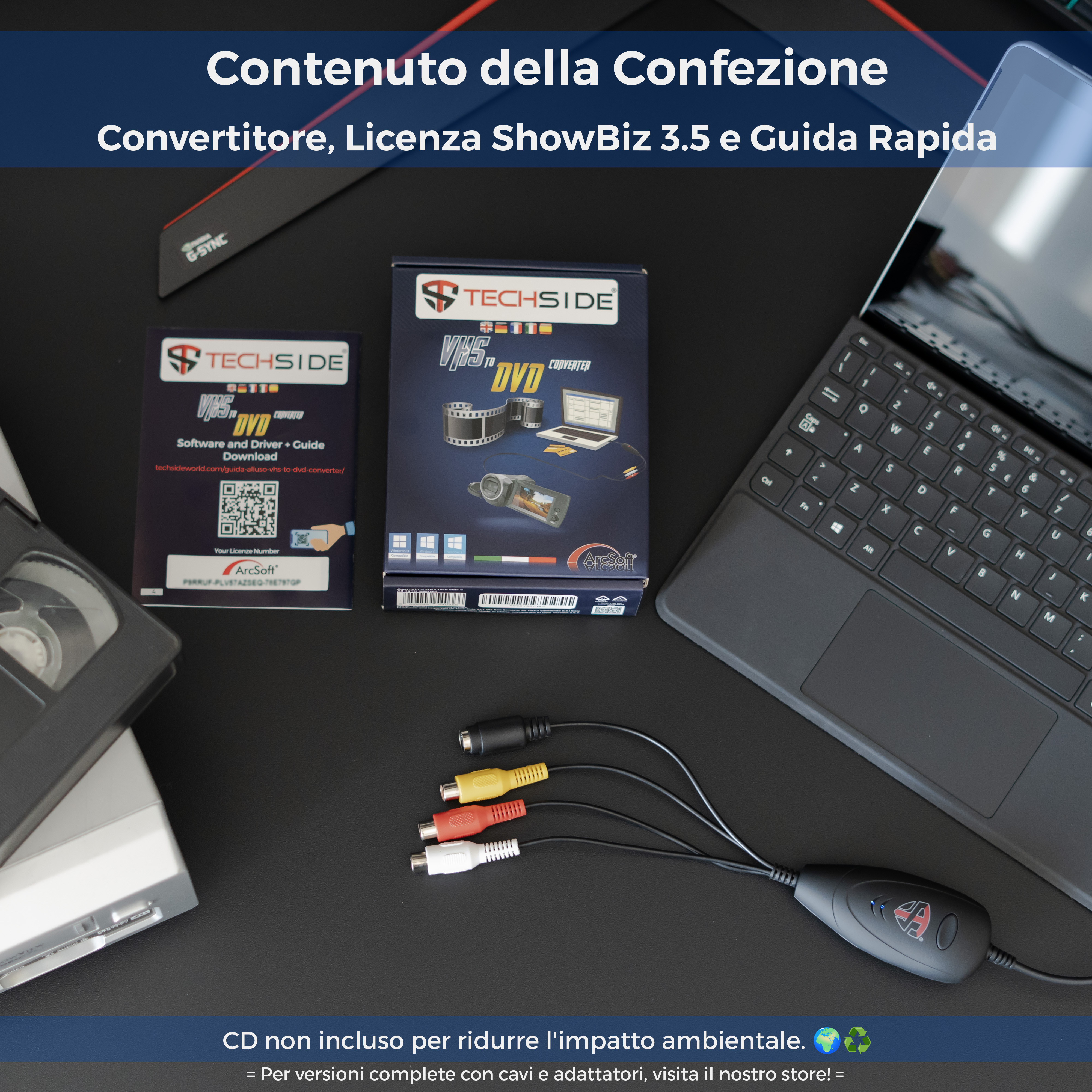 Una scatola convertitore Vhs a DVD, un laptop e cavi su una superficie nera. Il testo indica il contenuto.