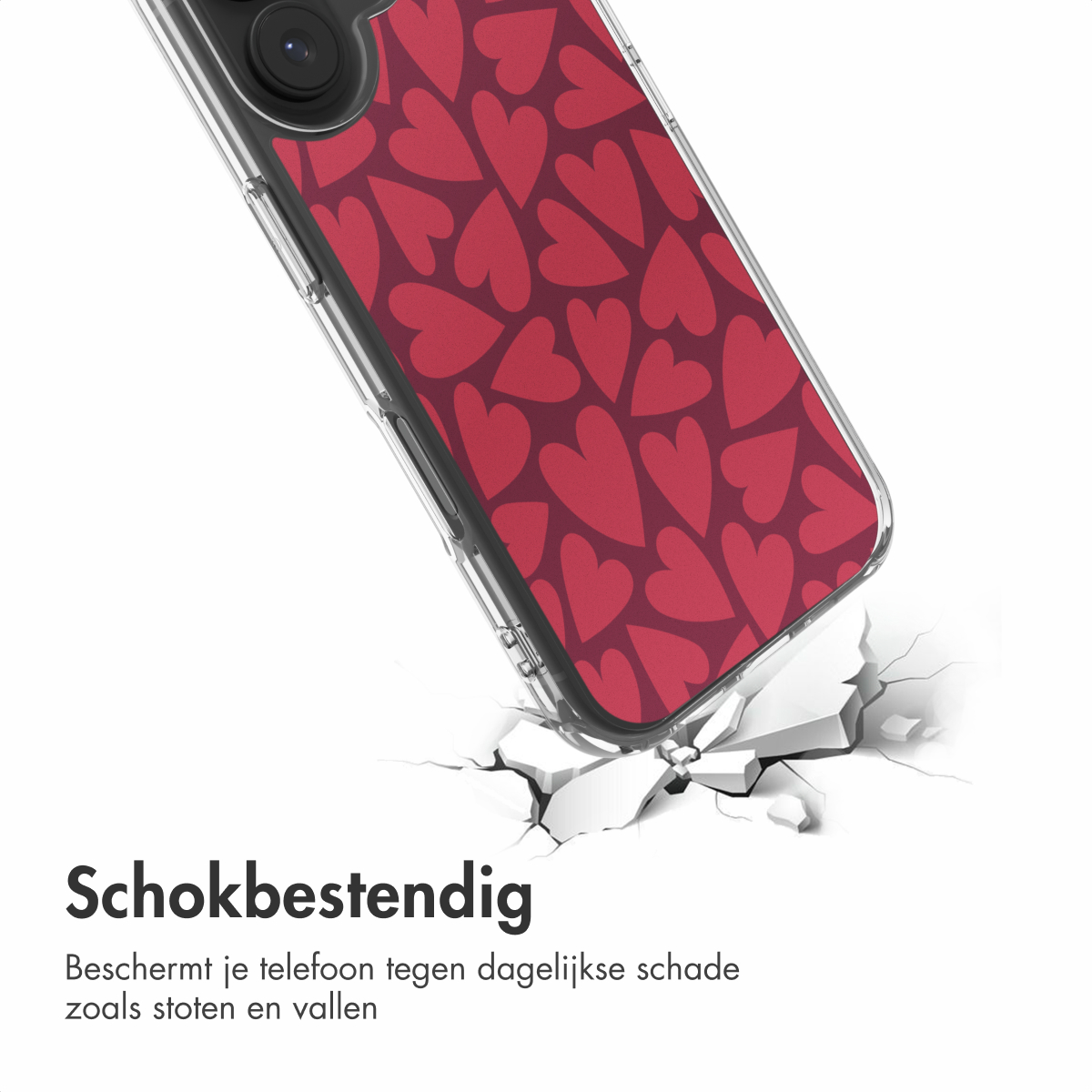 Een telefoonhoesje met rood hartpatroon breekt een oppervlak, wat de schokbestendigheid aantoont. Tekst 'Schokbestendig' eronder.