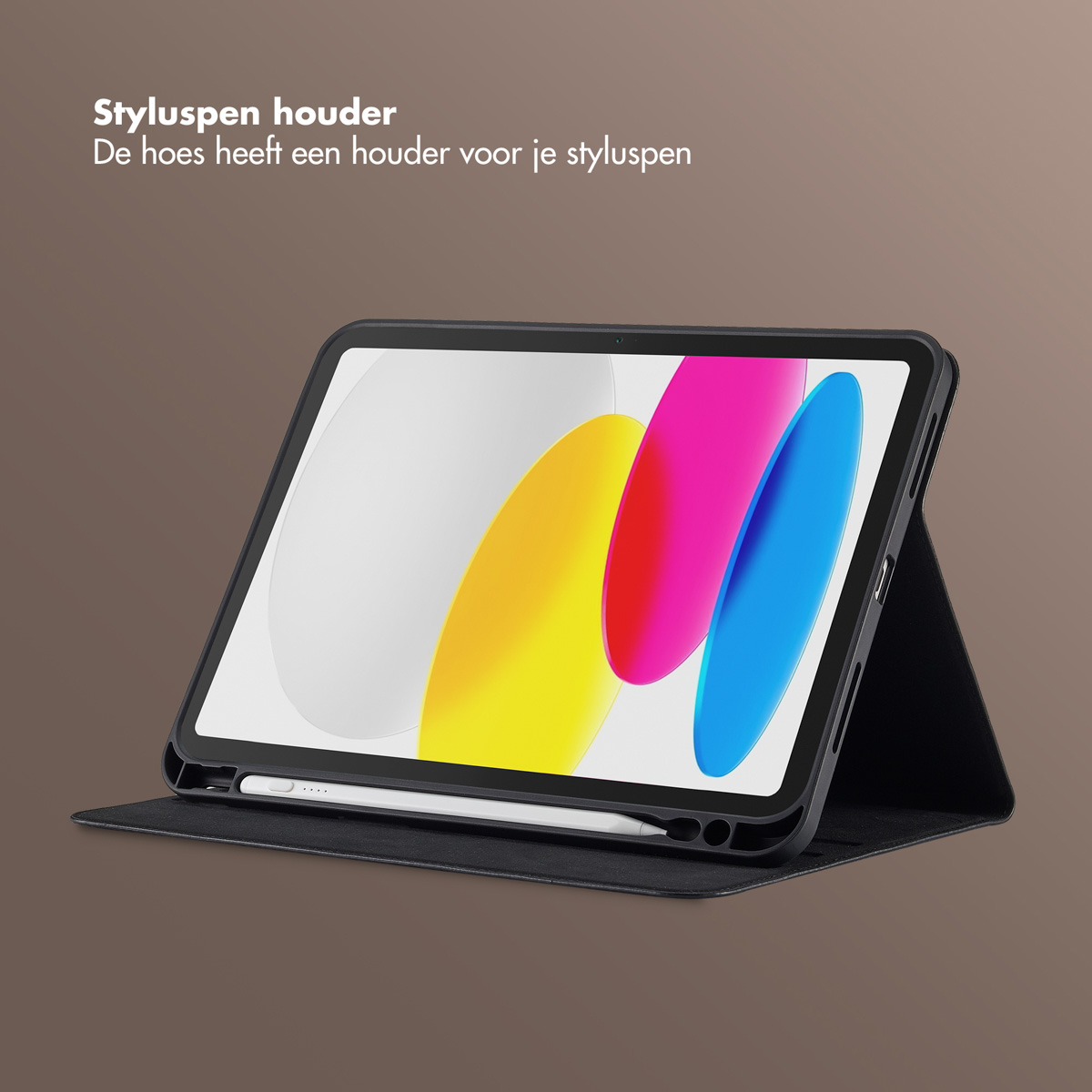 An iPad in a black case with a stylus pen. The screen displays colorful shapes. The case is on a brown surface.