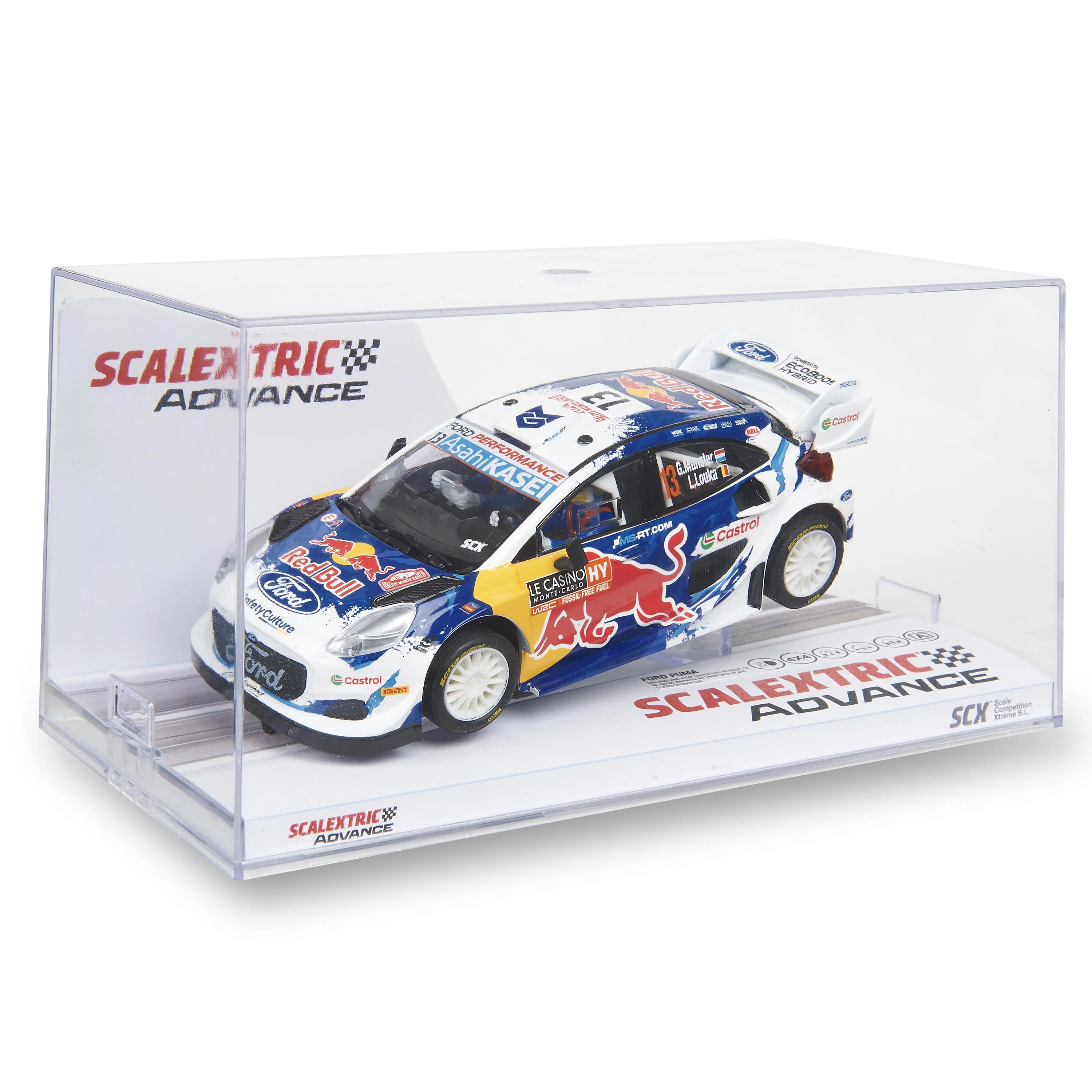 Un modelo de coche de carreras en una caja transparente. Tiene logotipos de patrocinadores y un logotipo de Red Bull. El coche es blanco, azul y amarillo.