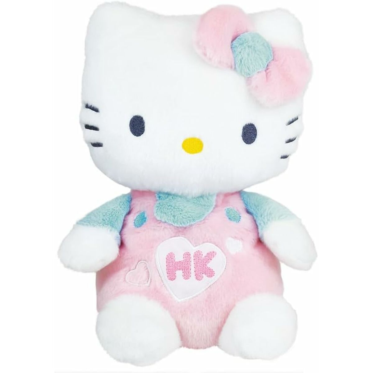Ein Hello Kitty Plüschtier. Es hat einen weißen Kopf mit einer rosa Schleife, blaue Augen und eine gelbe Nase. Es trägt eine rosa Latzhose.
