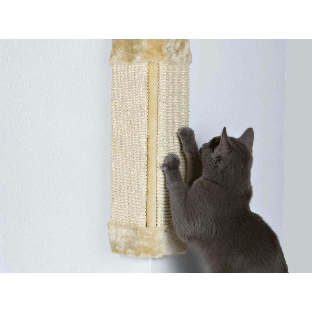 Un gato gris rasca un rascador beige en una pared blanca. El poste tiene un borde de piel sintética.