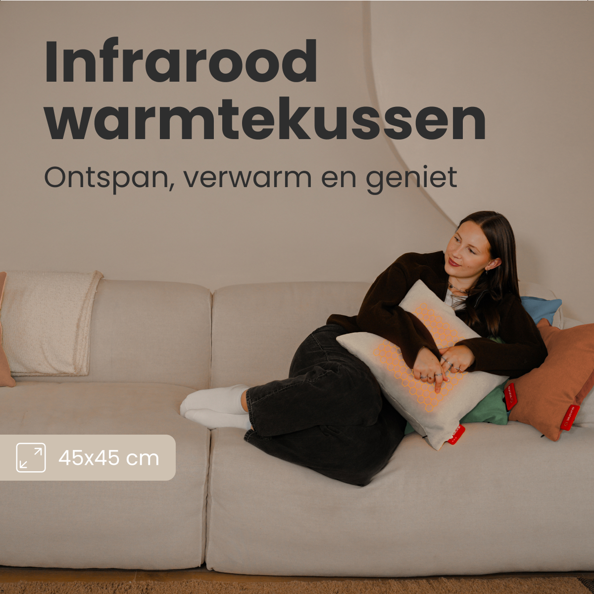 Woman on a sofa with pillows. Text says 'Infrared warmtekussen'. She holds a pillow with an orange pattern, and other pillows in the background.