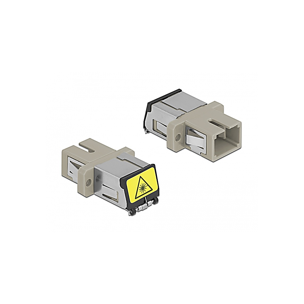Due connettori in fibra ottica beige e argento su sfondo bianco. Uno ha un'etichetta di avvertimento.