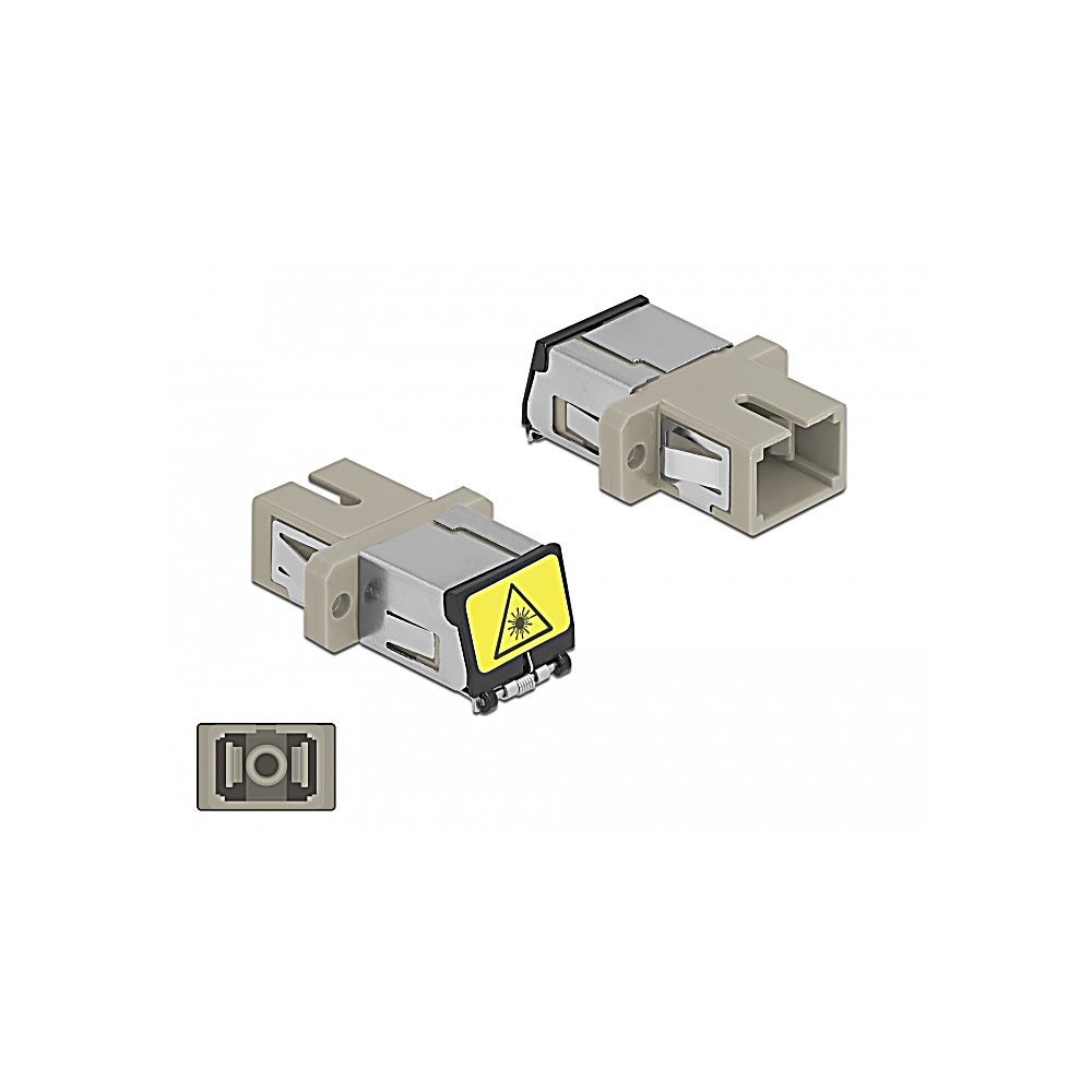 Due connettori in fibra ottica beige e grigio, uno con un'etichetta di avvertimento. Un connettore più piccolo è visibile anche in basso.