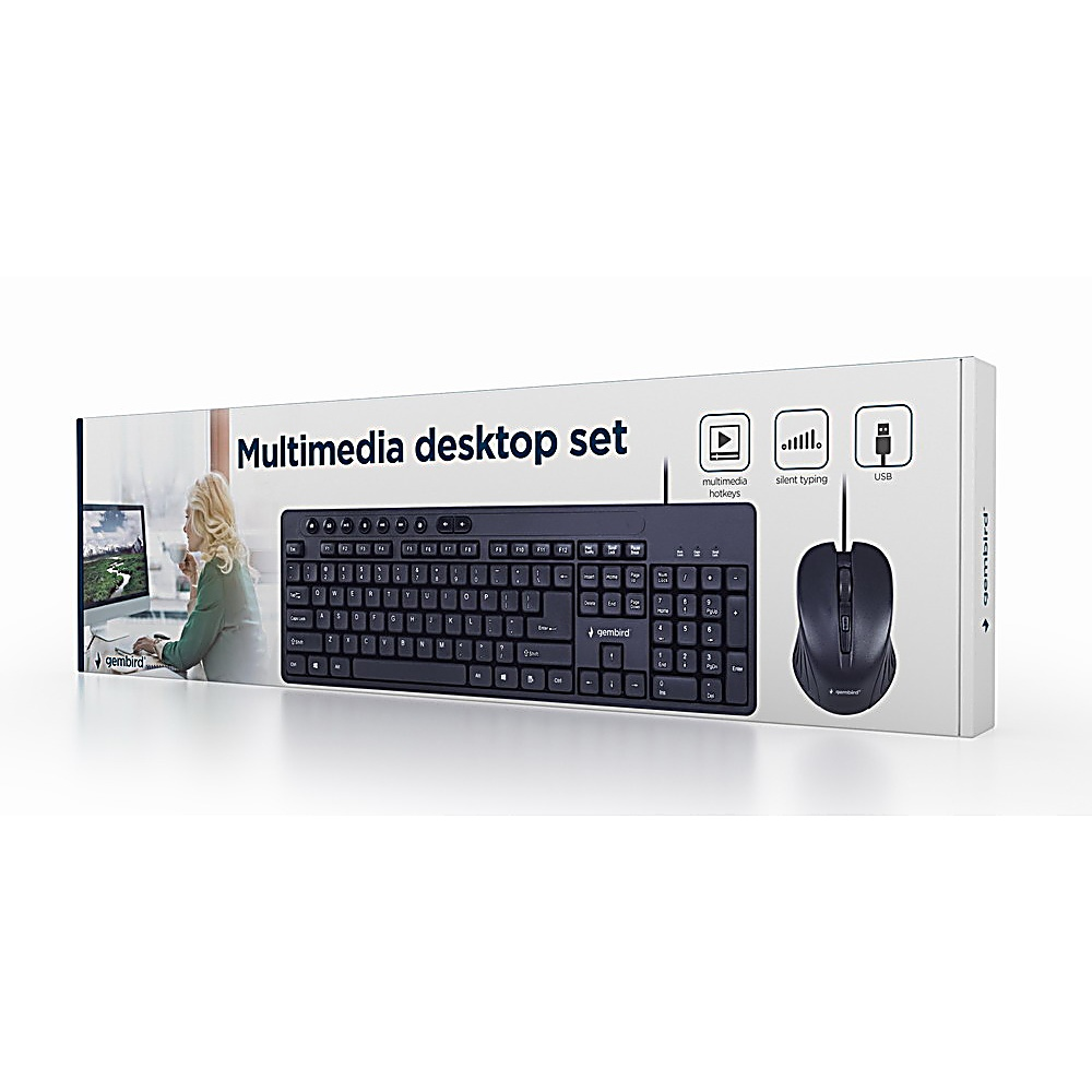 Un set desktop multimediale nella sua confezione. Include tastiera e mouse neri. La scatola mostra una donna che usa un computer.