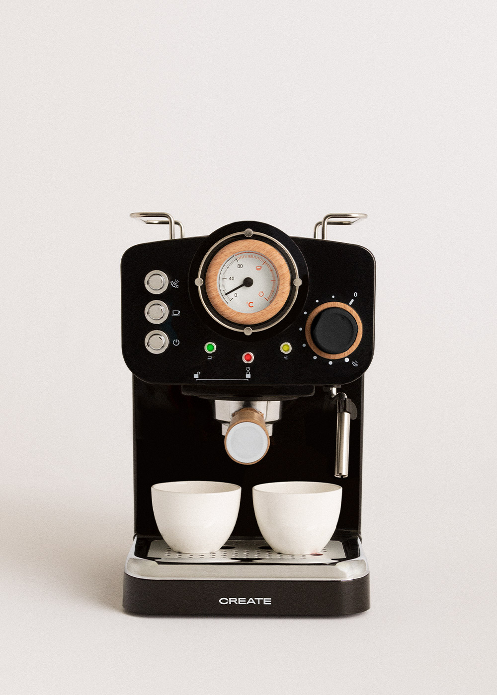 Máquina de espresso negra con detalles de madera. Dos tazas blancas debajo de la boquilla. Se ven un medidor y botones.