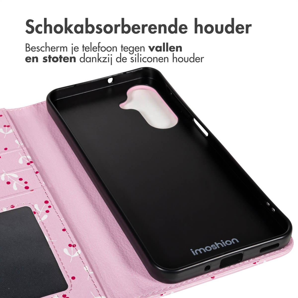 Coque de téléphone noire sur fond floral rose. Le texte en haut indique 'Schokabsorberende houder'.
