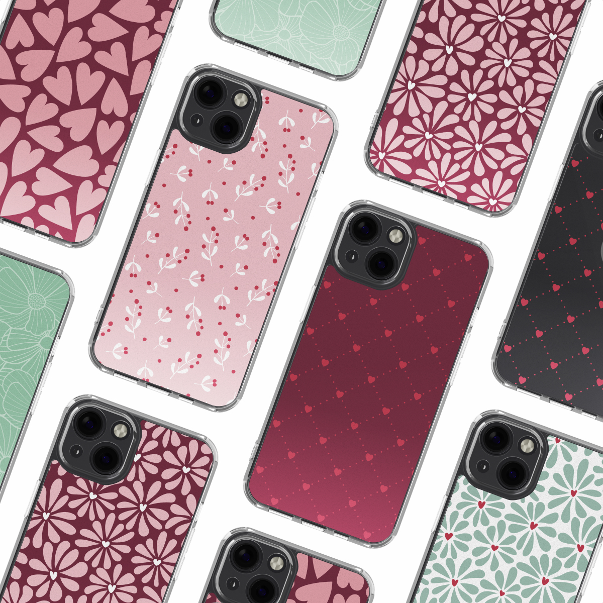 Varie custodie per smartphone con diversi motivi come cuori, fiori e ramoscelli di bacche in rosa, rosso e verde, su sfondo bianco.