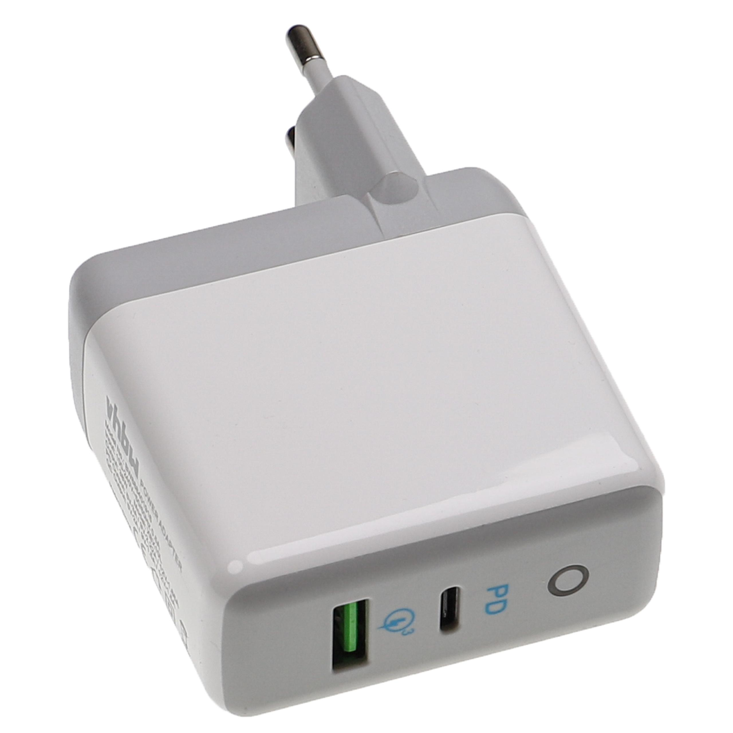 Ein weißes und graues Ladegerät mit Stecker. Es hat einen grünen Anschluss und einen USB-C-Anschluss. Der Lader steht vor weißem Hintergrund.