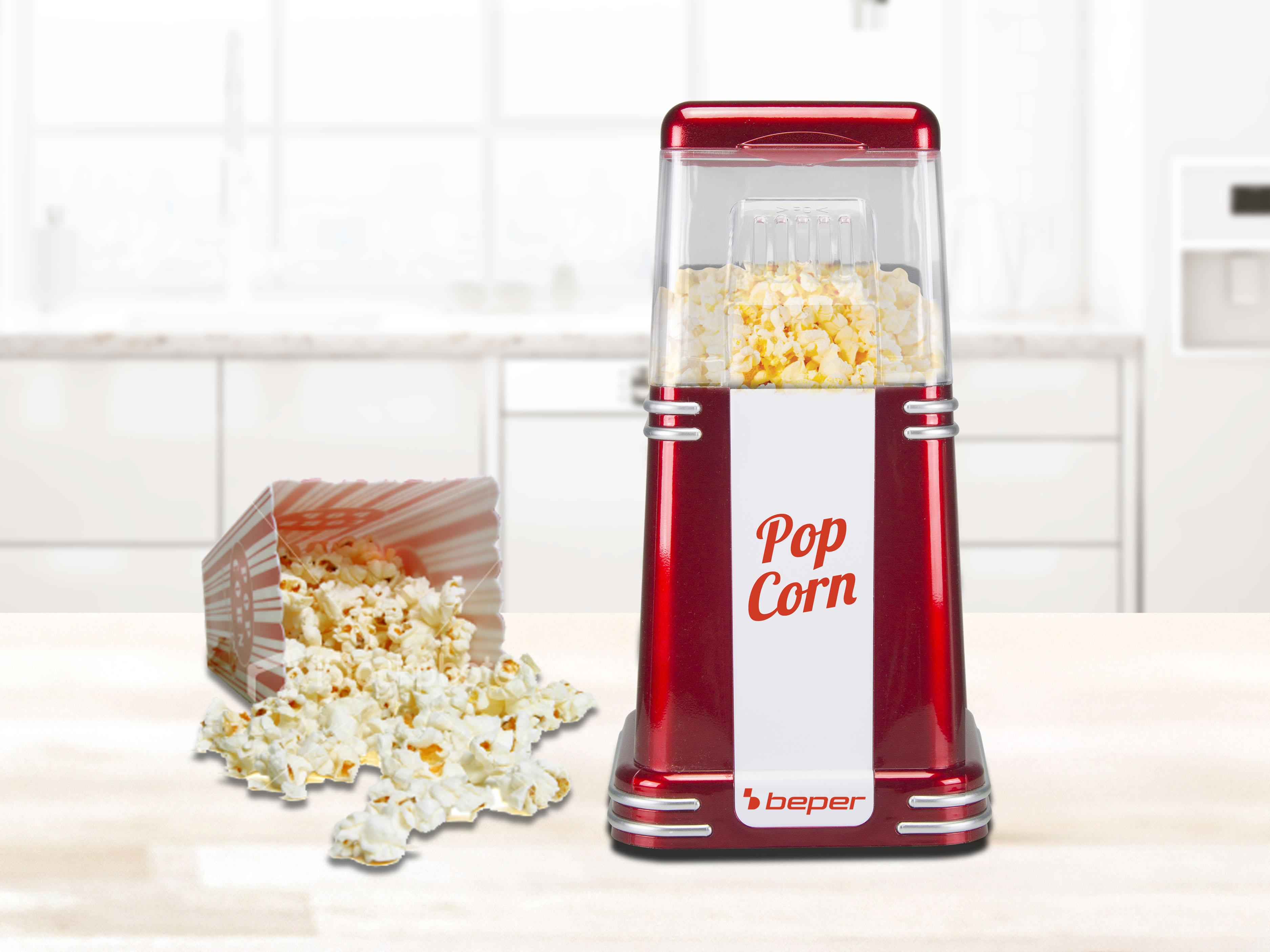 Una macchina per popcorn rossa con popcorn all'interno, popcorn versato e una scatola a righe rosse e bianche.