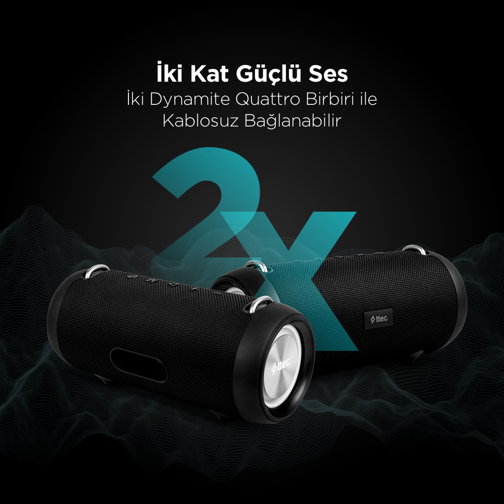 İki adet siyah silindirik hoparlör. Metin: 'iki Kat Güçlü Ses' ve 'iki Dynamite Quattro Birbiri ile Kablosuz Bağlanabilir'. Turkuaz '2x' grafik.
