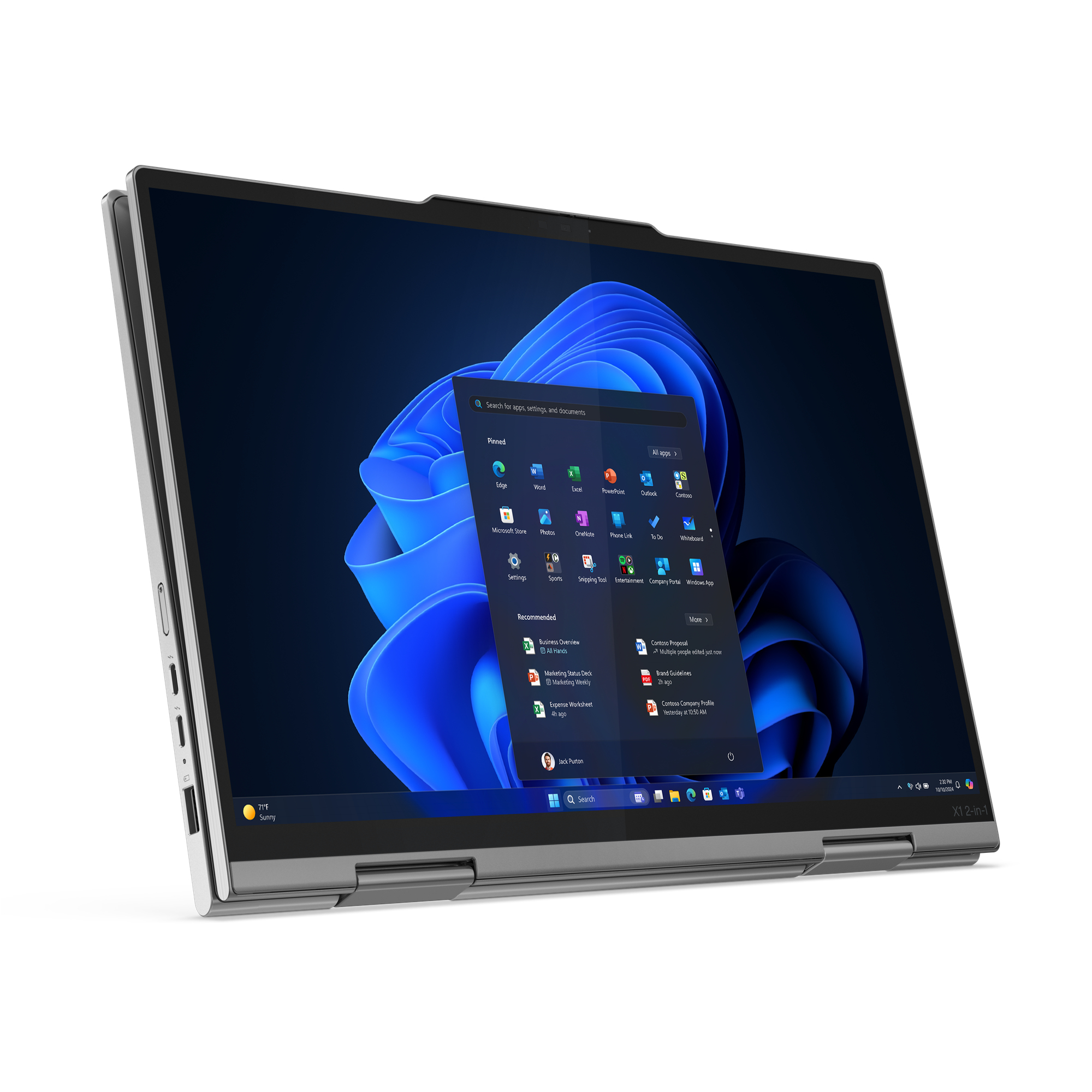 Srebrny laptop jest otwarty, wyświetlając interfejs Windows 11. Ekran pokazuje niebieskie tło i ikony aplikacji.