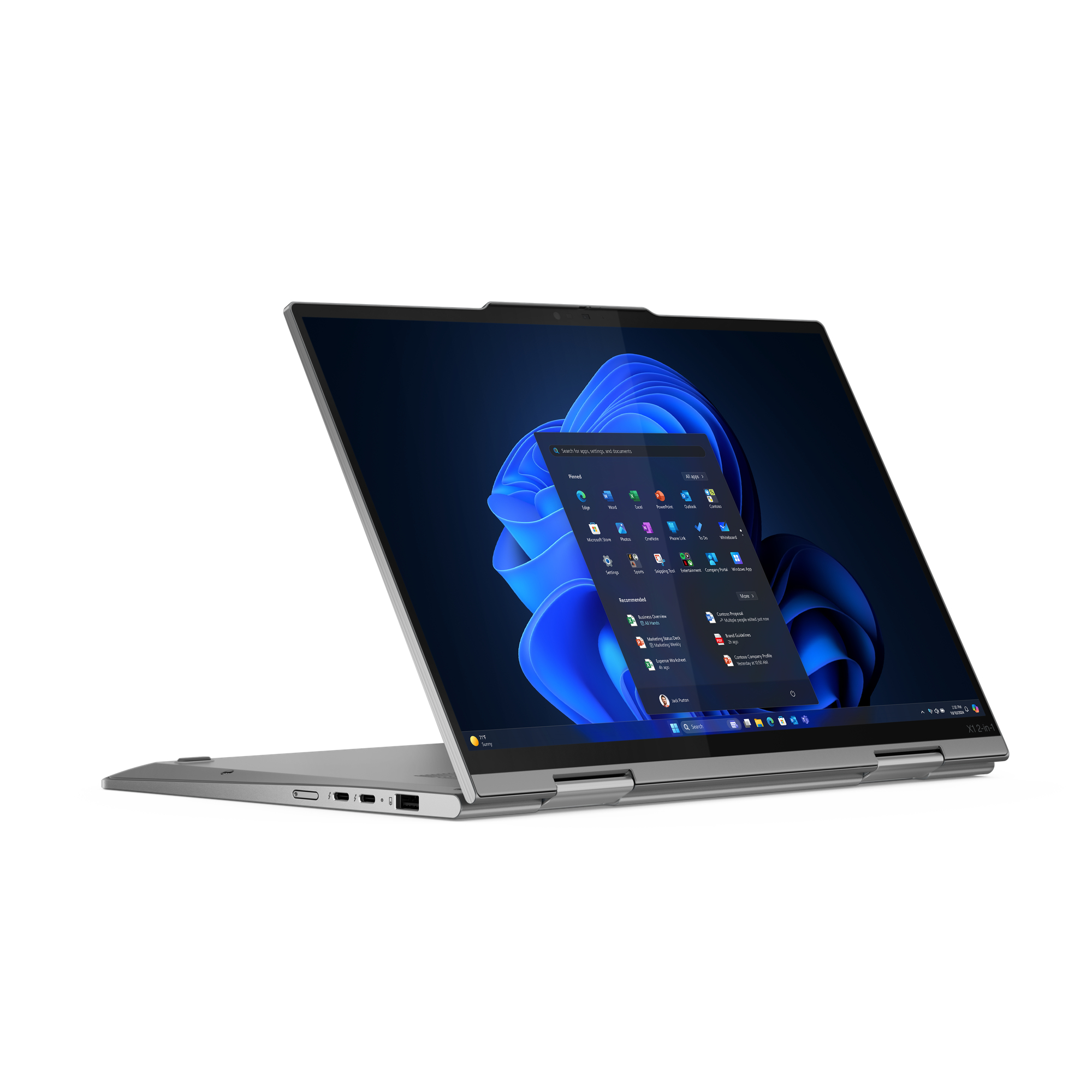 Otwarty srebrny laptop, wyświetlający interfejs Windows 11 z ikonami aplikacji. Ekran pokazuje niebieskie abstrakcyjne tło.