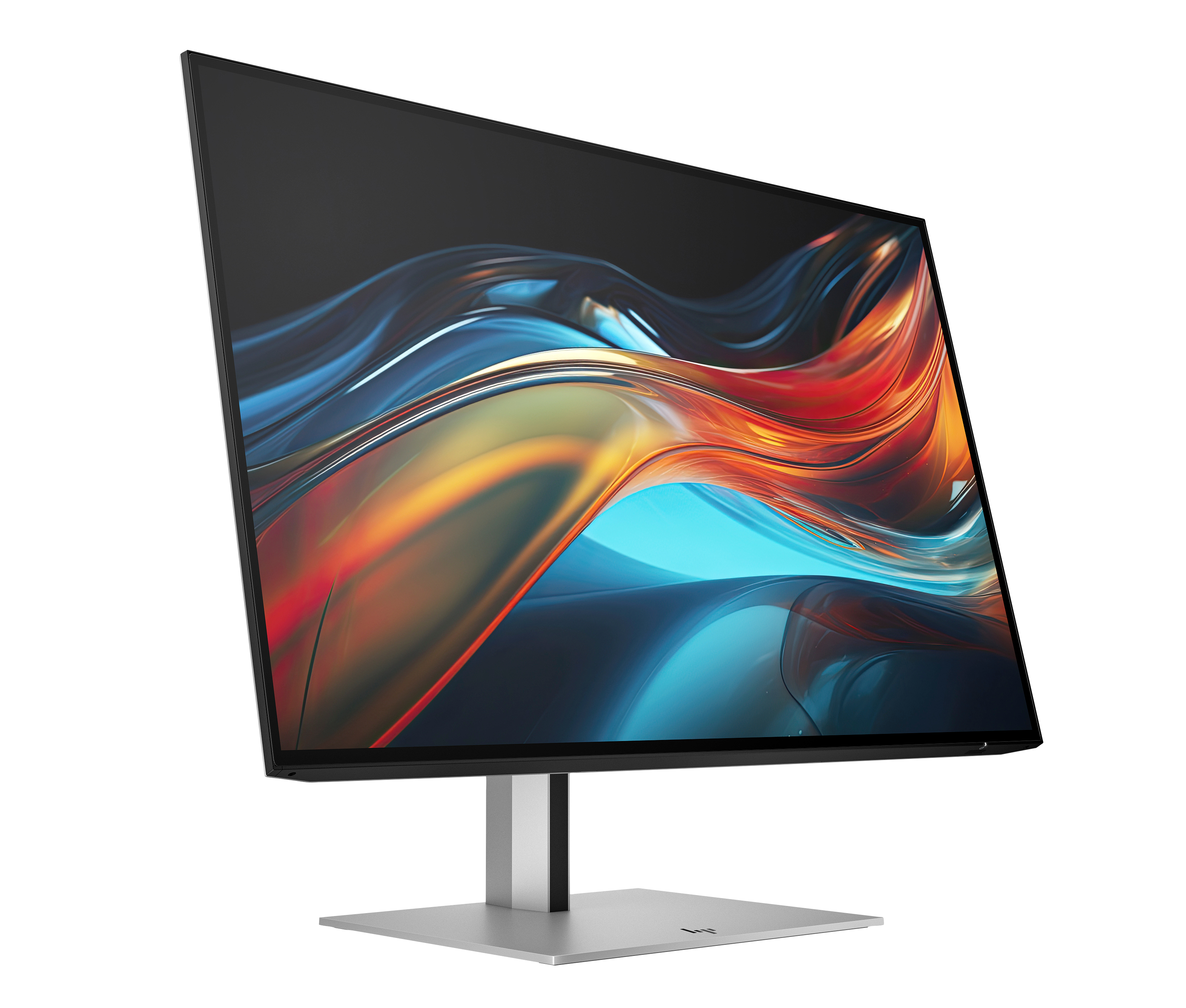 Un moderno monitor per computer su sfondo bianco. Lo schermo mostra forme astratte colorate. La base è argentata.