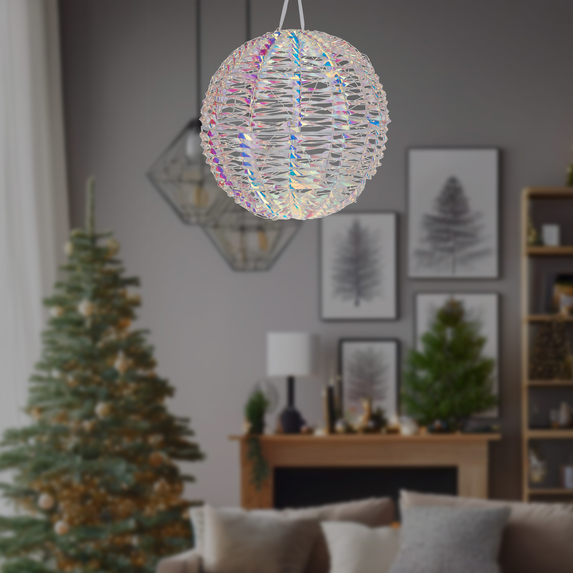 Una lámpara decorativa esférica cuelga en una habitación. Hay un árbol de Navidad al fondo. La habitación tiene una chimenea y arte enmarcado.