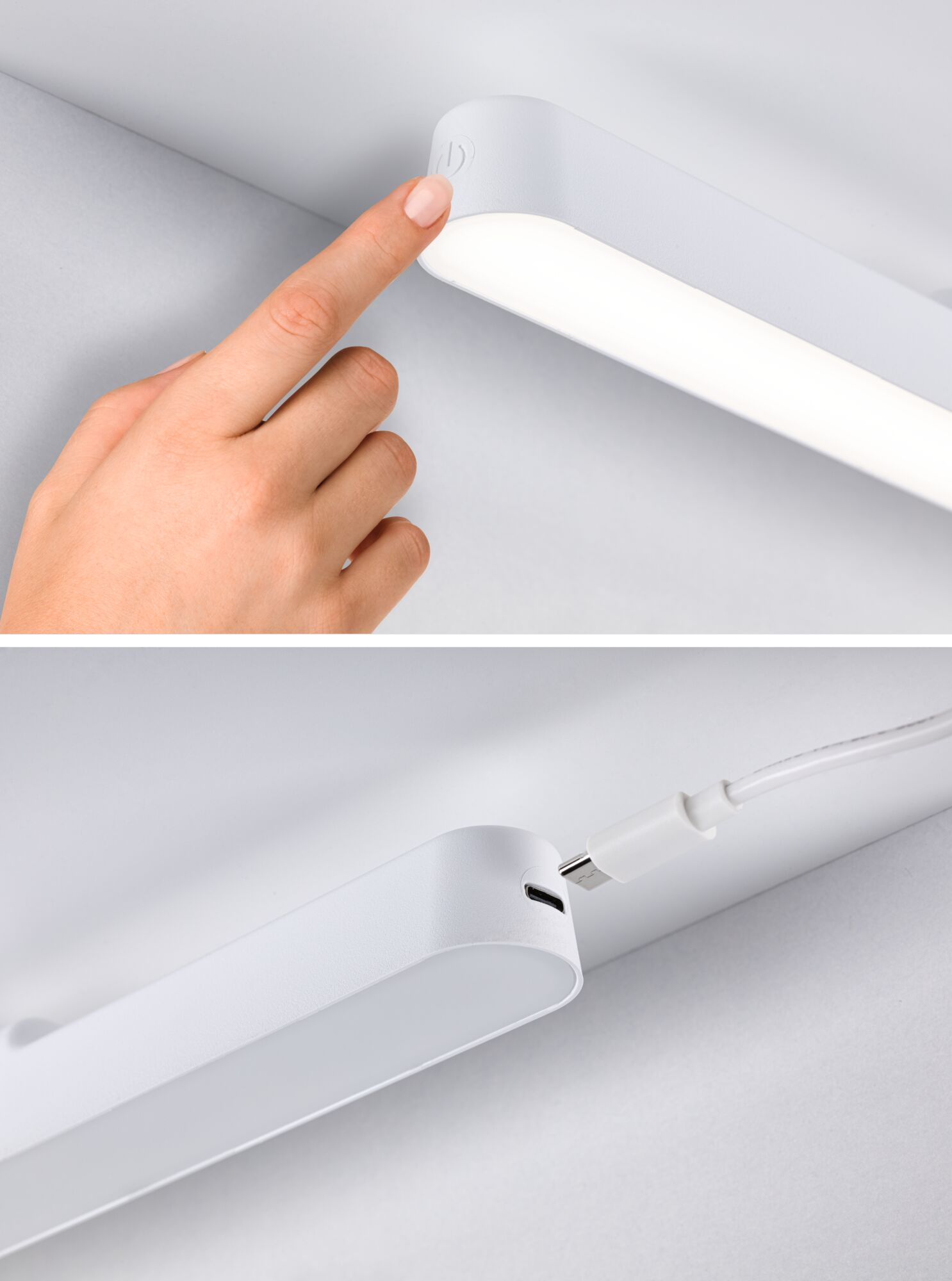 Eine Hand berührt eine weiße LED-Leuchte. Das Licht ist eingeschaltet und mit einem USB-Kabel an einer weißen Wand befestigt.