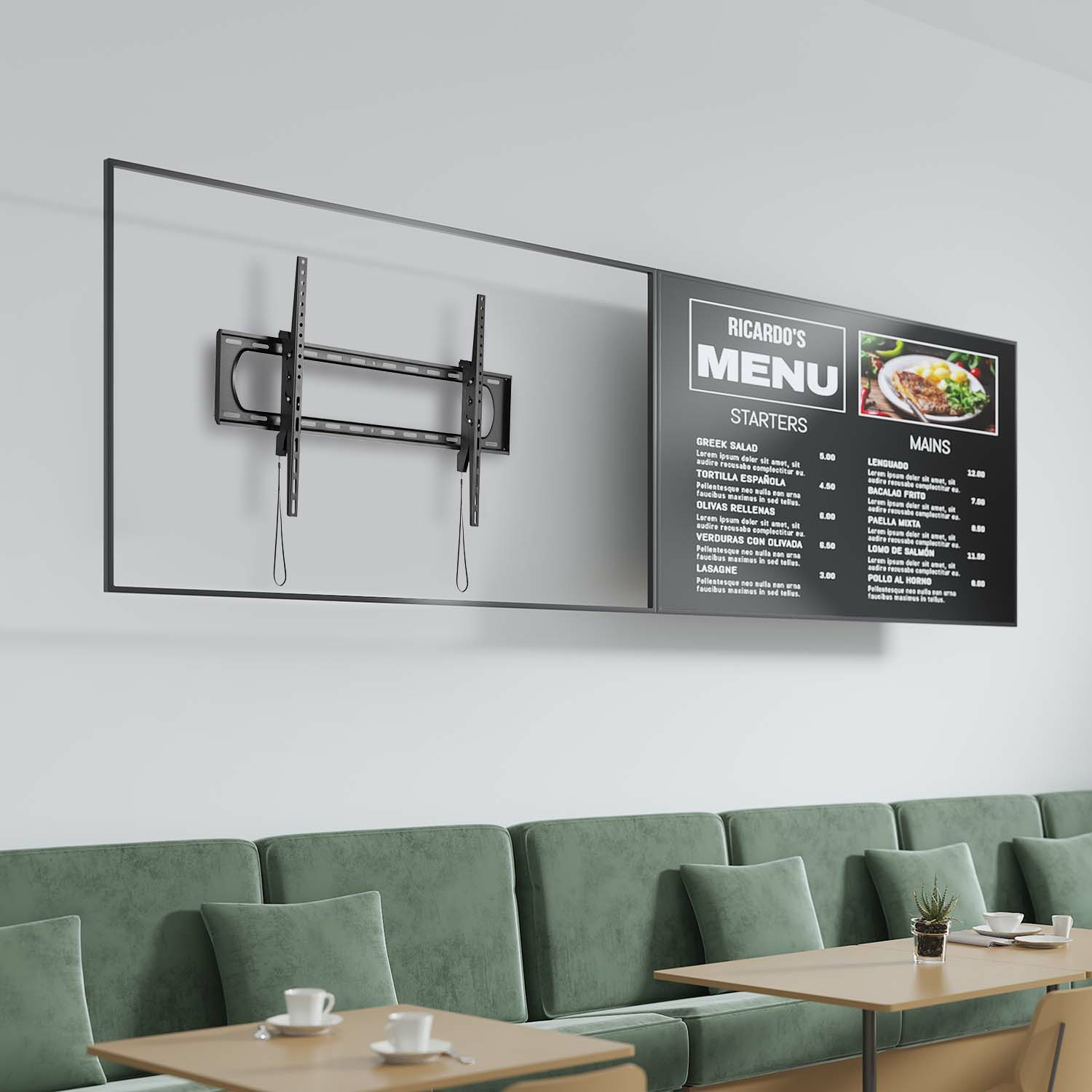 Interior del restaurante con un menú en una pantalla, un soporte de TV y un sofá verde. Mesas con tazas blancas al frente.