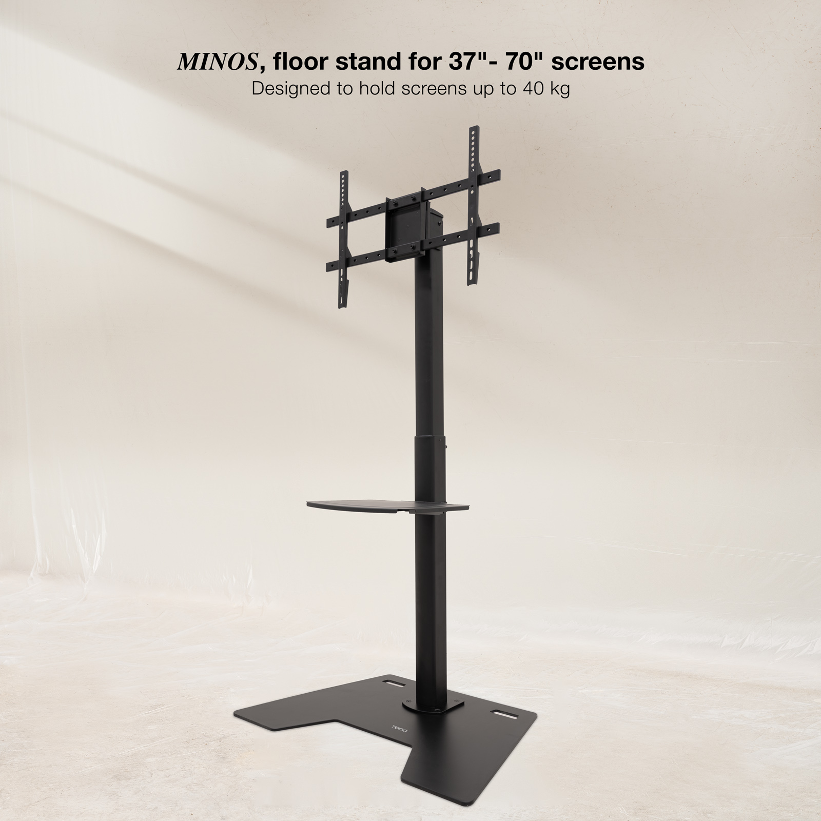 Un supporto TV nero. Ha una base, un palo verticale e un supporto per schermo. È presente una piccola mensola.