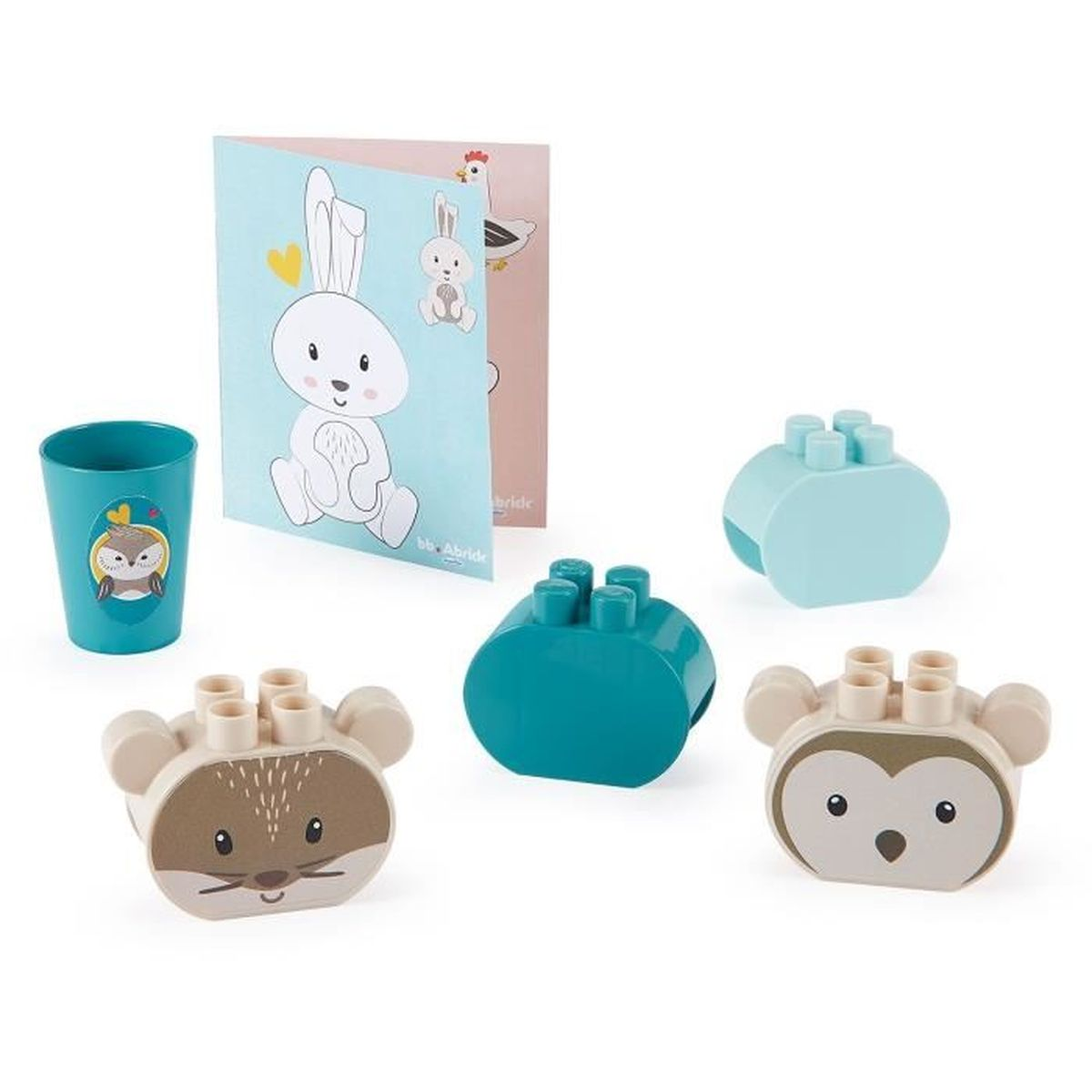 Un set di giocattoli per bambini, tra cui blocchi, una tazza con un gufo e una carta con illustrazioni di animali.