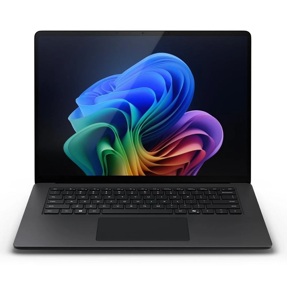 Un portátil negro está abierto, mostrando una imagen abstracta colorida. El teclado y el panel táctil son visibles. El fondo es blanco.