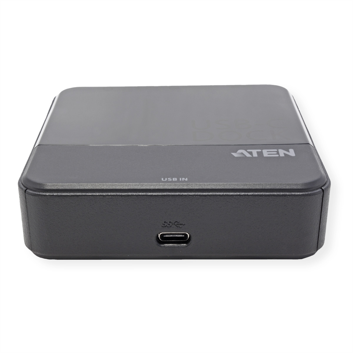Ein dunkelgrauer ATEN USB-C Dock, rechteckig mit abgerundeten Kanten, beschriftet mit 'USB IN'. Ein USB-C-Anschluss ist sichtbar. Weißer Hintergrund.