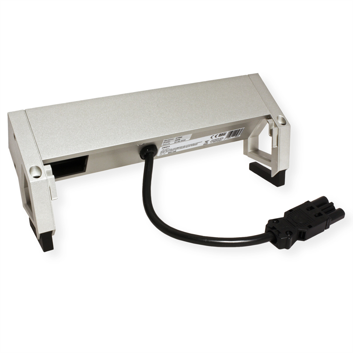 Srebrne prostokątne urządzenie z czarnymi nóżkami i czarnym kablem zakończonym czarnym złączem. Urządzenie spoczywa na białej powierzchni.