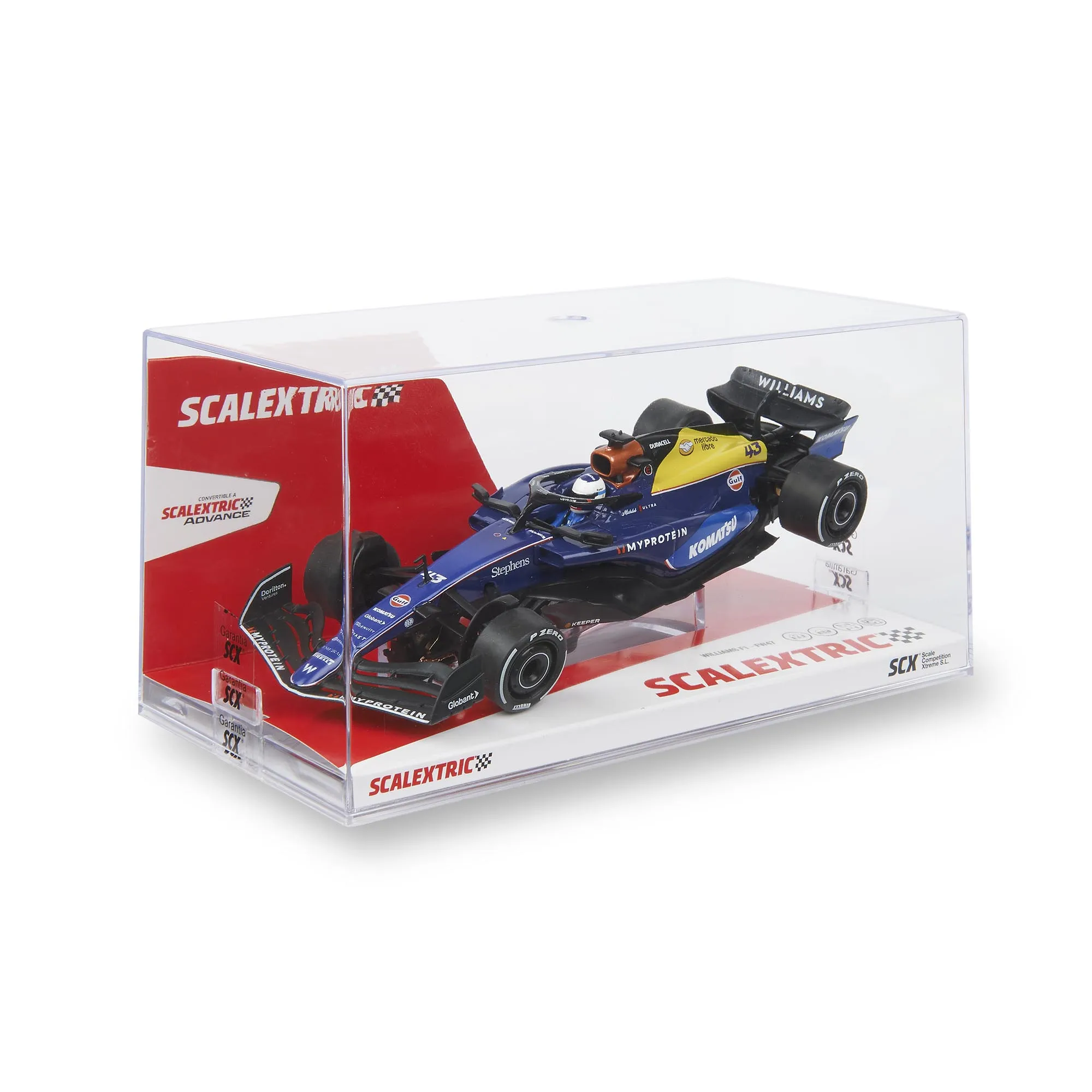 Un modelo de coche Williams F1 azul y amarillo en una caja transparente. Marcas incluyen Myprotein, Komatsu y Gulf.