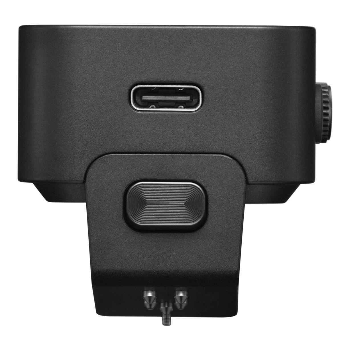 Close-up of a black device with a USB port, button, and screw. The device has a textured surface and metallic pins at the bottom.