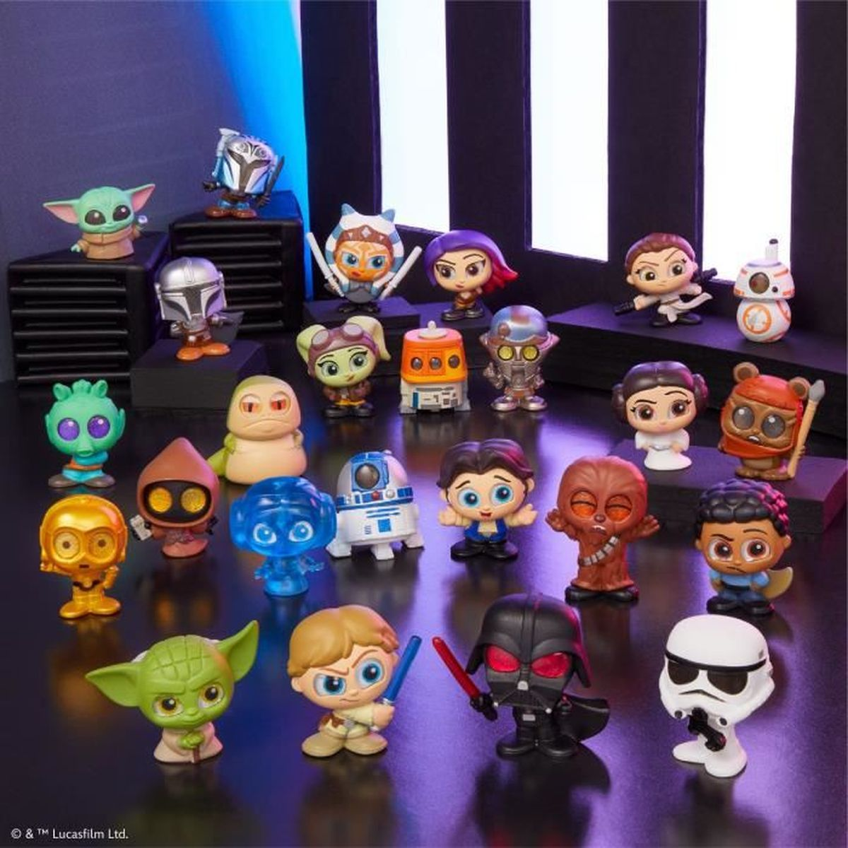 Sammlung von Star-Wars-Charakterfiguren, darunter Yoda, Darth Vader und Sturmtruppen, auf einer Oberfläche mit dunklem Hintergrund angeordnet.
