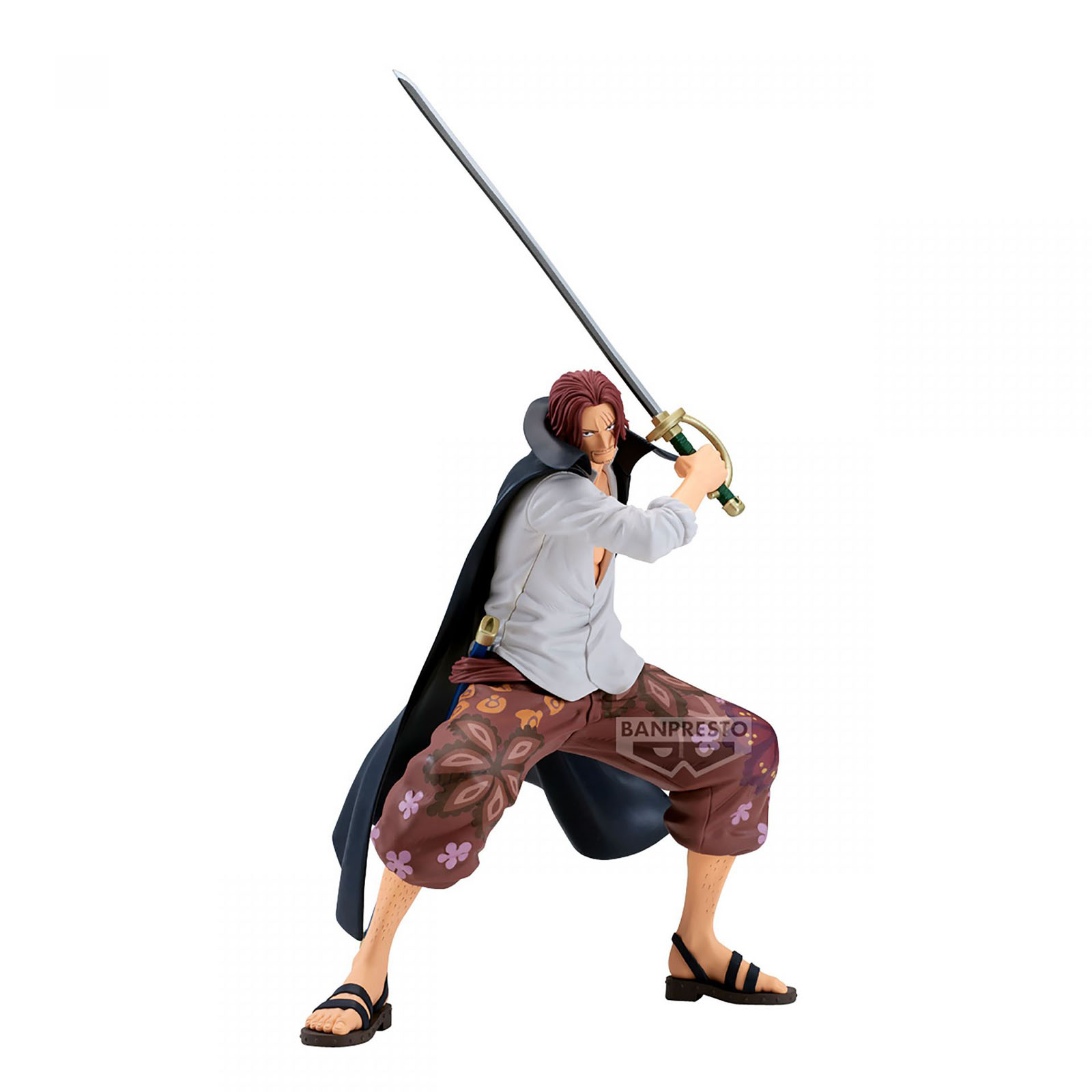 Figur eines Mannes mit roten Haaren, der ein Schwert hält. Er trägt ein weißes Hemd, eine gemusterte Hose und Sandalen. Er hat einen schwarzen Umhang.