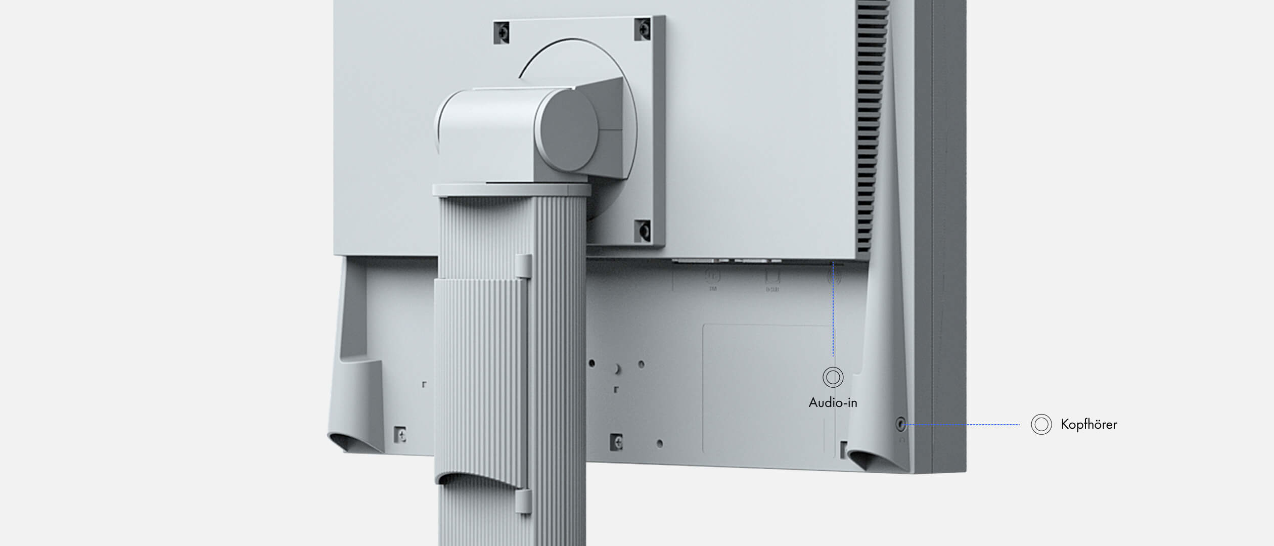 Widok z tyłu jasnoszarego monitora komputera. Widoczne są porty wejścia audio i słuchawek, wraz ze stojakiem i szczelinami wentylacyjnymi.