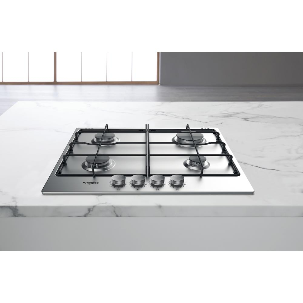 Ein Edelstahl-Whirlpool-Gaskochfeld mit vier Brennern und Bedienknöpfen auf einer weißen Marmorarbeitsplatte.