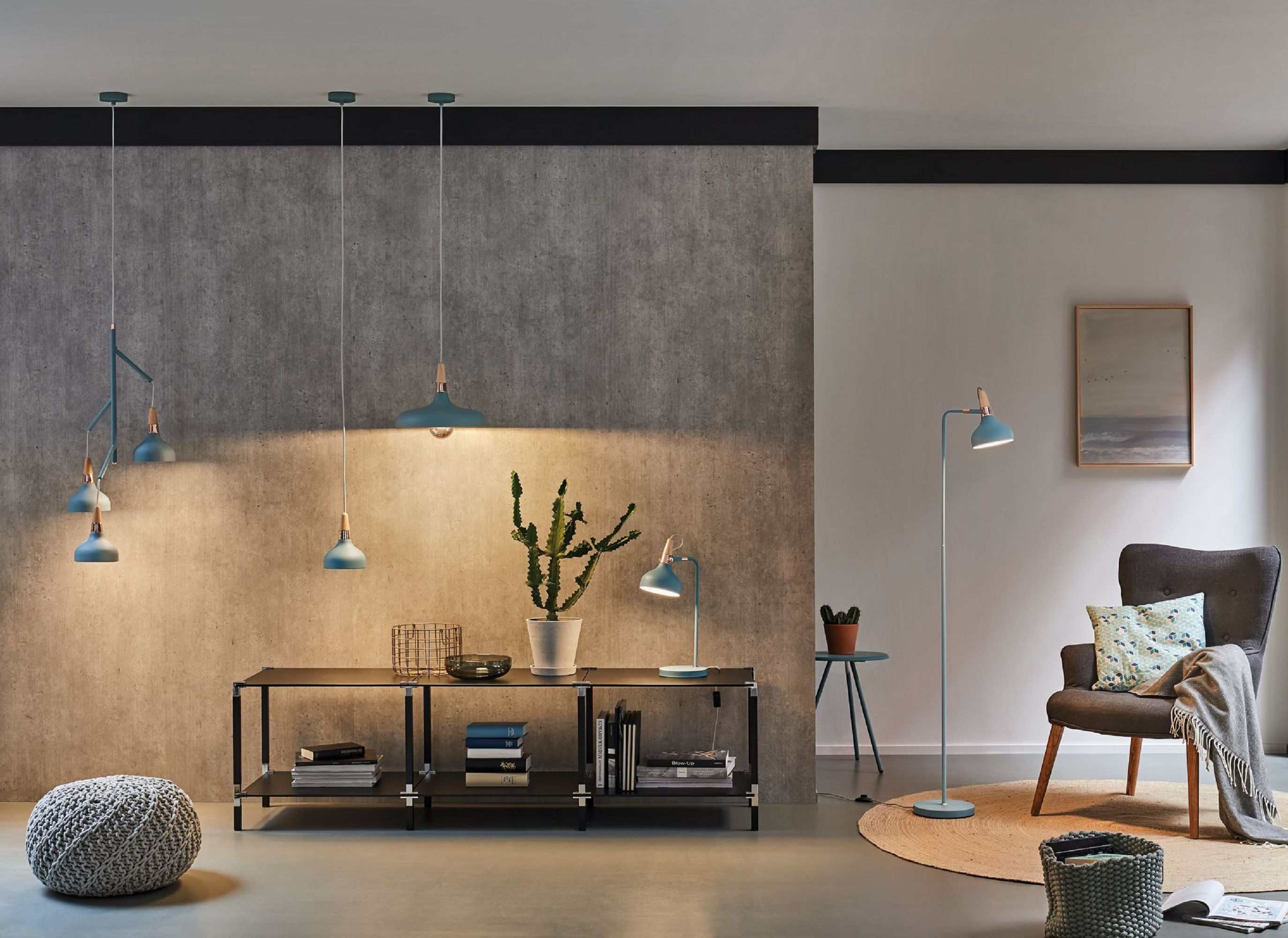 Nowoczesny salon z lampami, kaktusem, krzesłem i stolikiem, tworzący przytulną atmosferę.