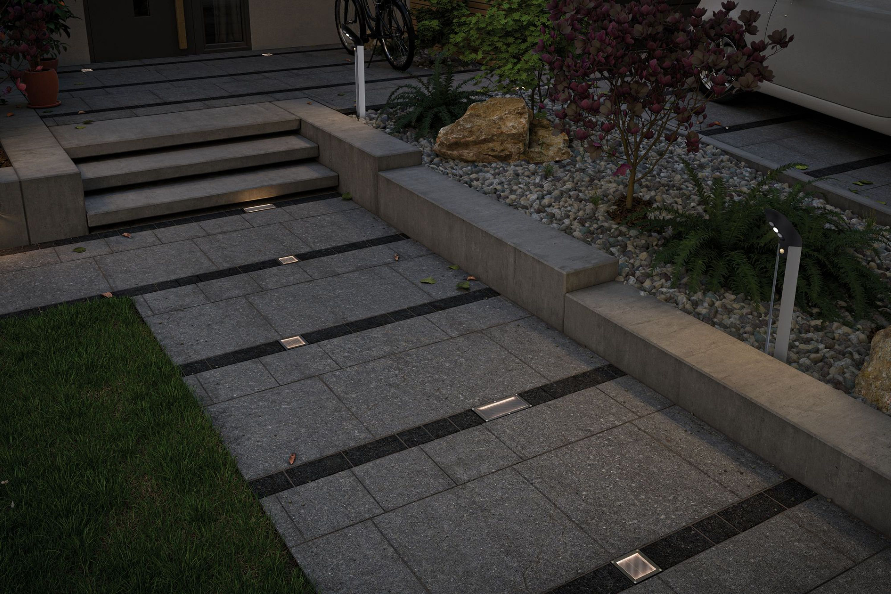 Nowoczesna scena na zewnątrz. Betonowa ścieżka ze światłami, schodami, roślinami i zaparkowanym samochodem. Rower w tle.