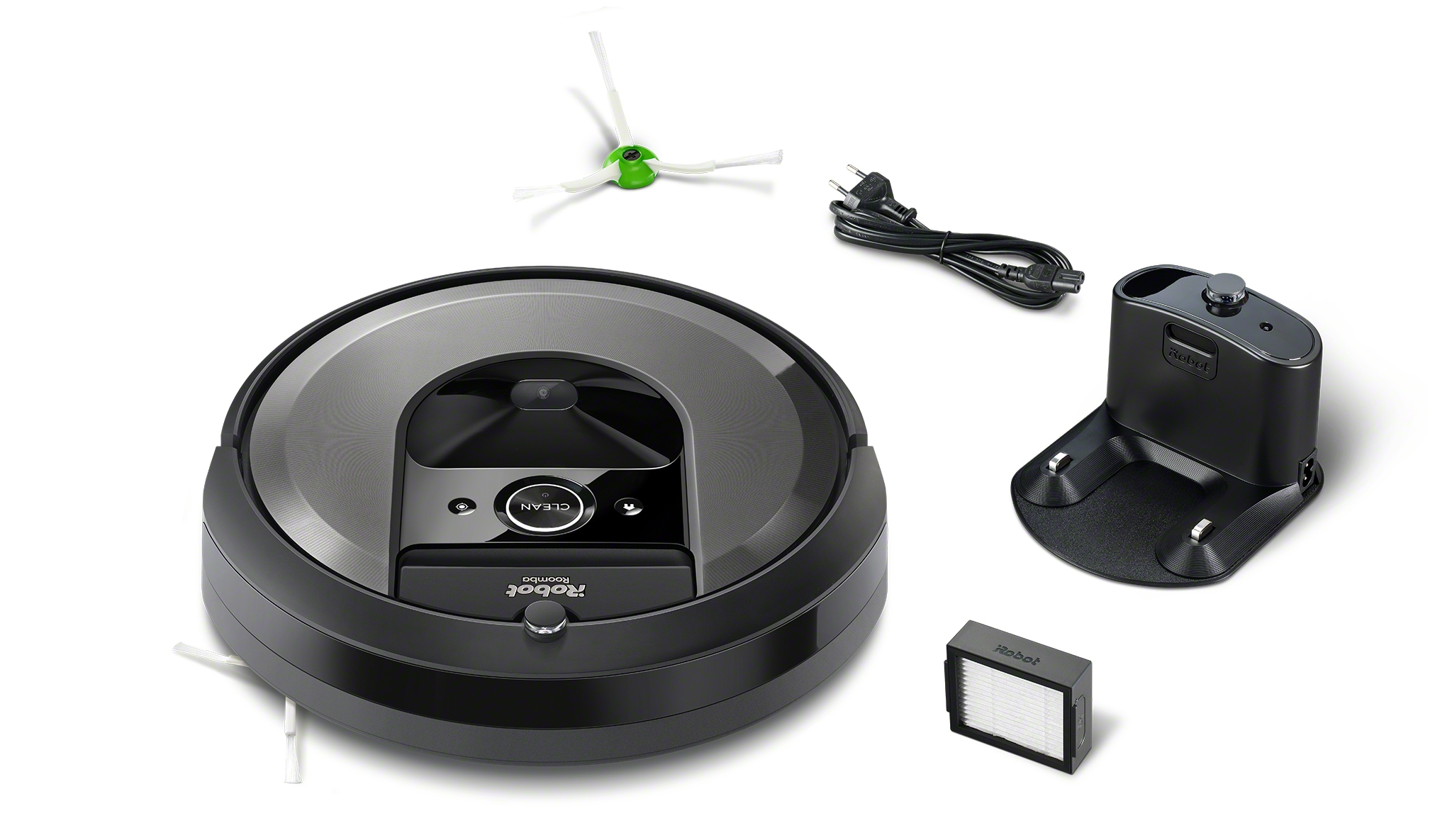 Un aspirateur robot Roomba noir et gris avec des accessoires comme un chargeur, un filtre et des brosses, le tout sur fond blanc.