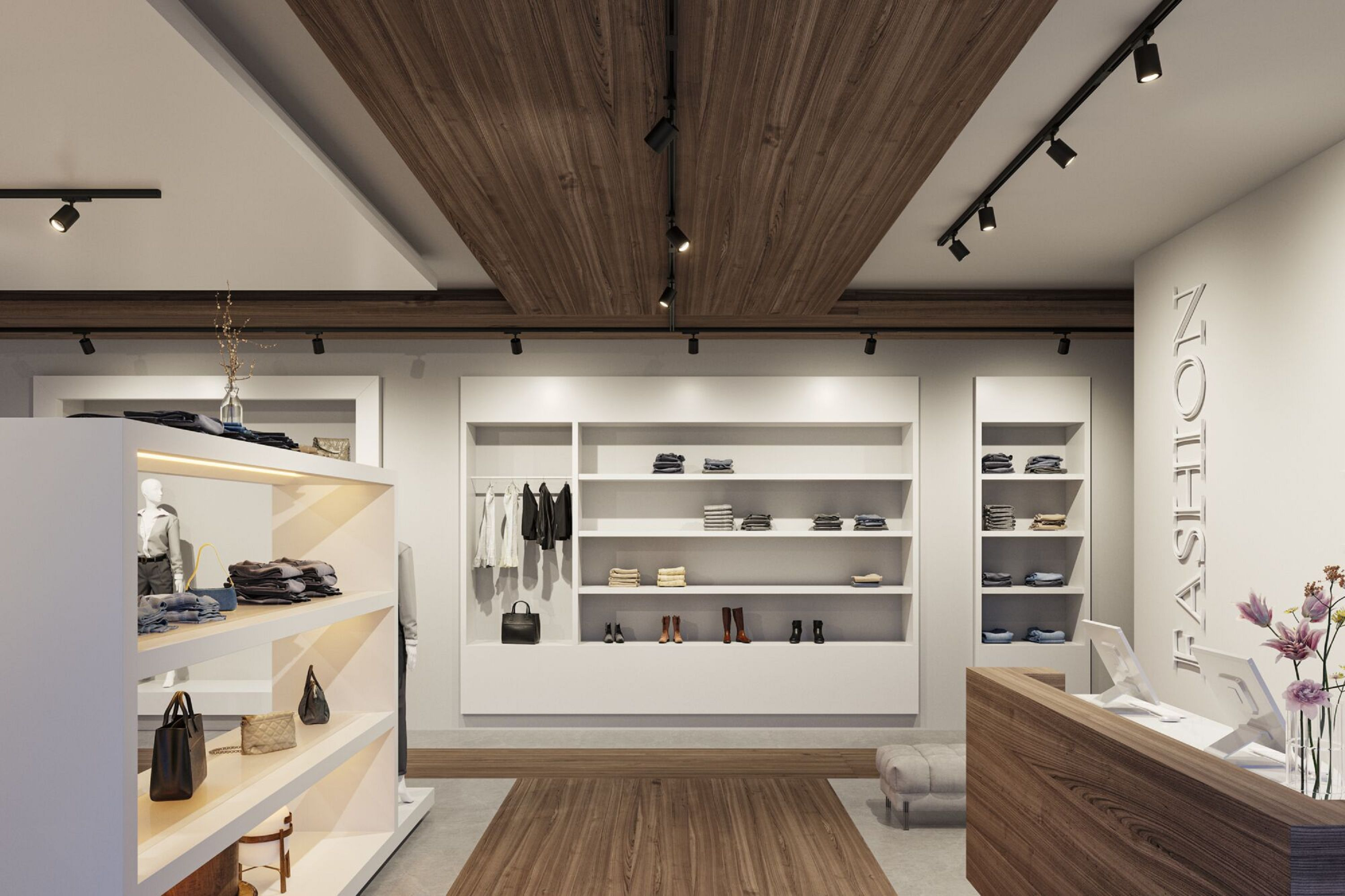 Wnętrze sklepu odzieżowego. Ubrania i akcesoria są eksponowane na półkach i wieszakach, z oświetleniem szynowym.