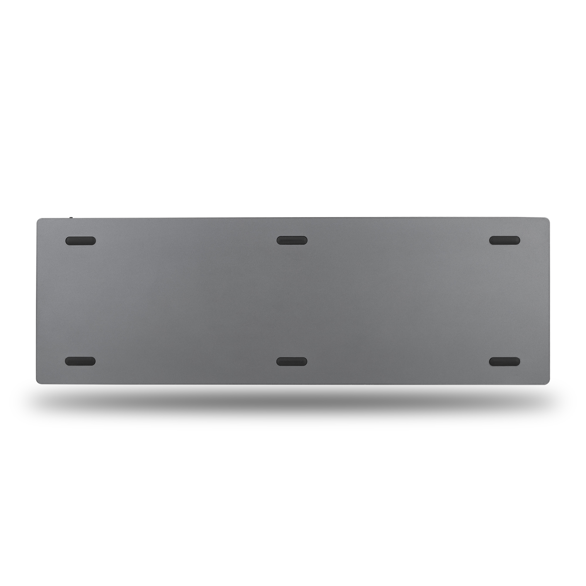 Un objeto rectangular gris con seis almohadillas negras en la parte inferior, sobre un fondo blanco.