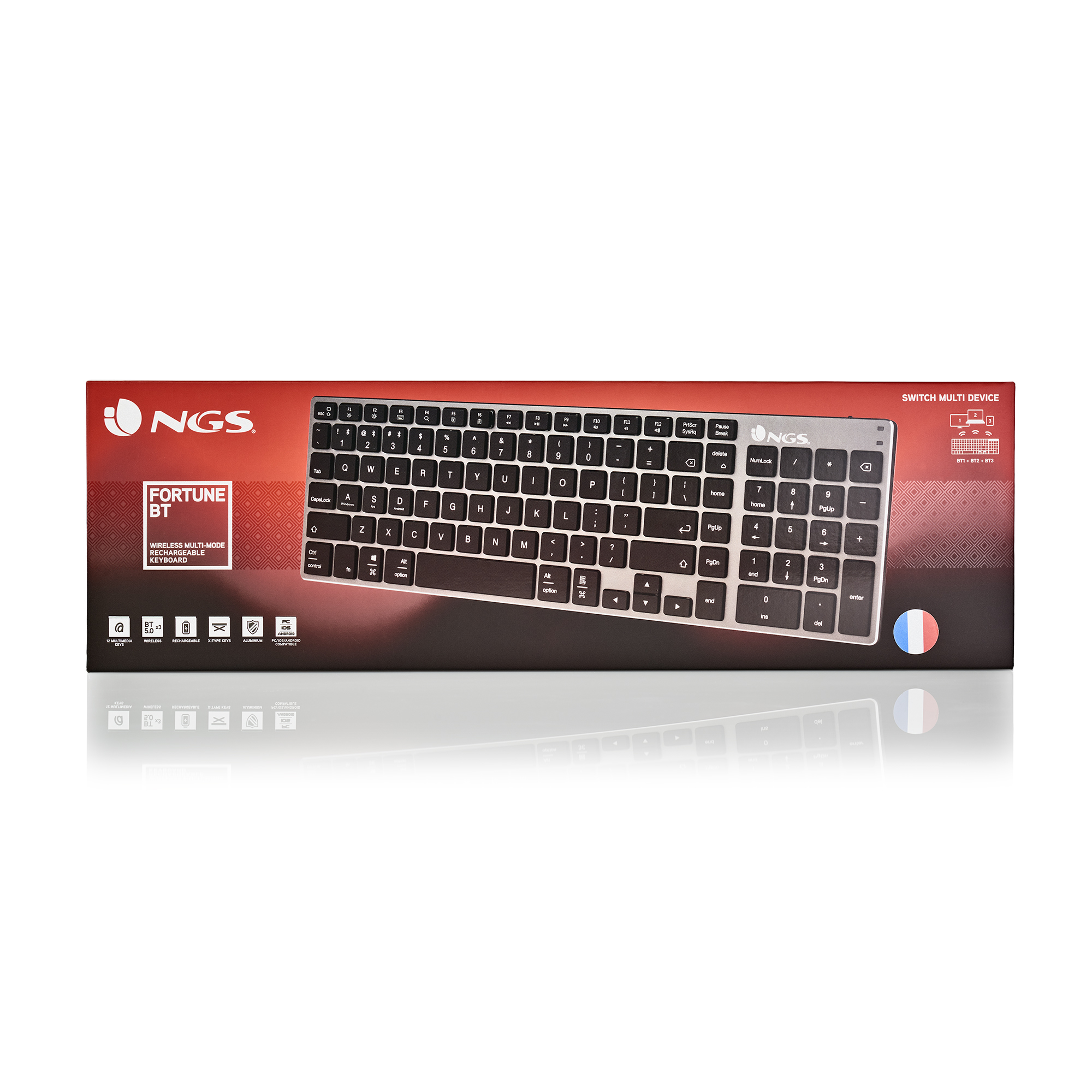 Pudełko z klawiaturą, srebrna klawiatura z czarnymi klawiszami. Marka NGS. Nazwa produktu Fortune BT. Inne funkcje, takie jak bezprzewodowy i ładowalny.