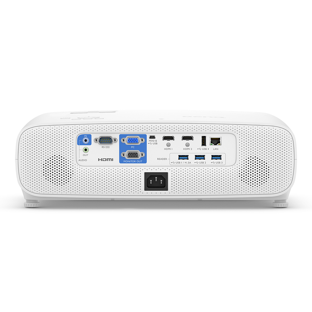 Retroproiettore bianco con porte: audio, HDMI, monitor, USB, LAN e alimentazione. Due altoparlanti.